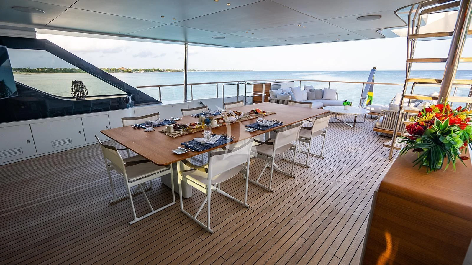 a large room with tables and chairs aboard KOJU Yacht for Sale