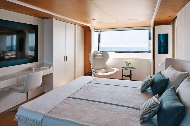 a bedroom with a bed and a desk aboard KOJU Yacht for Sale