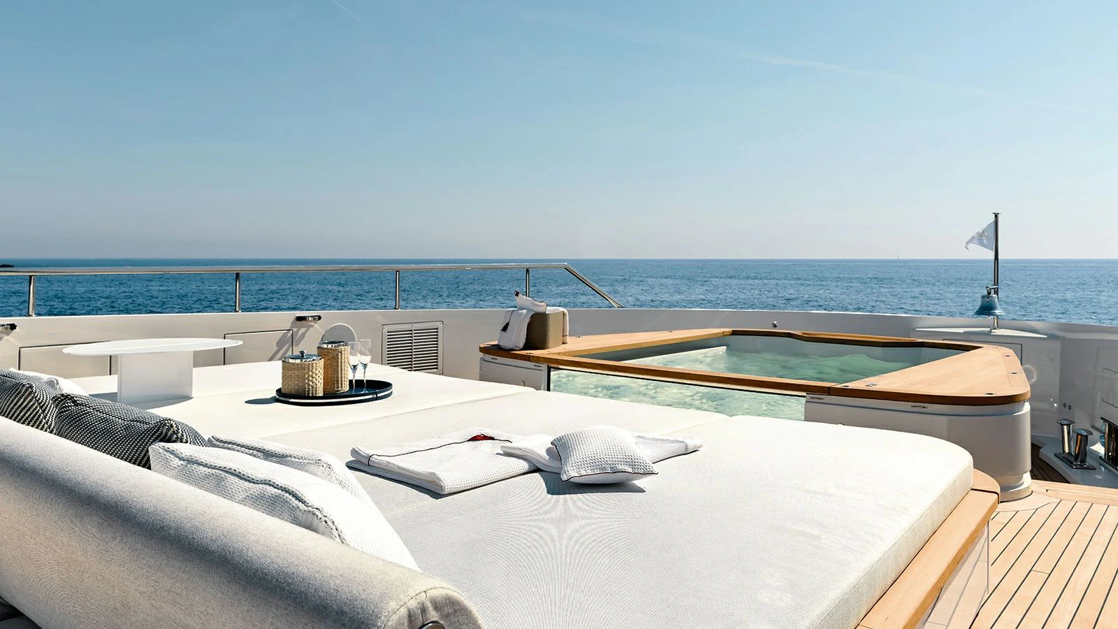 a bed on a balcony overlooking the ocean aboard KOJU Yacht for Sale