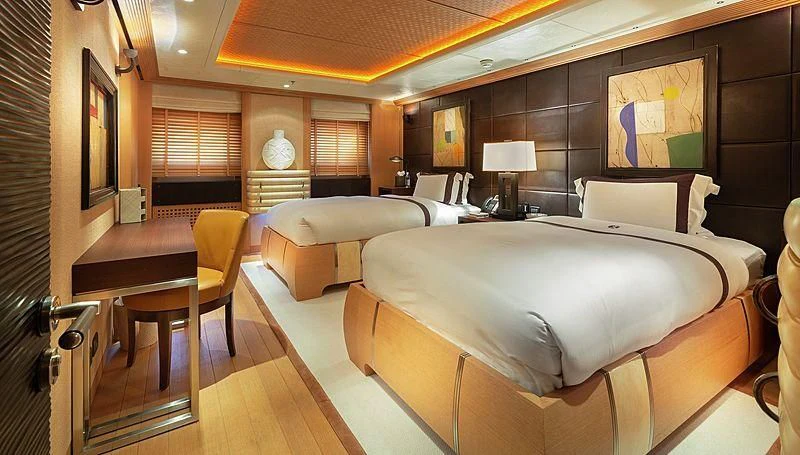 a room with a bed and a desk aboard KOJU Yacht for Sale