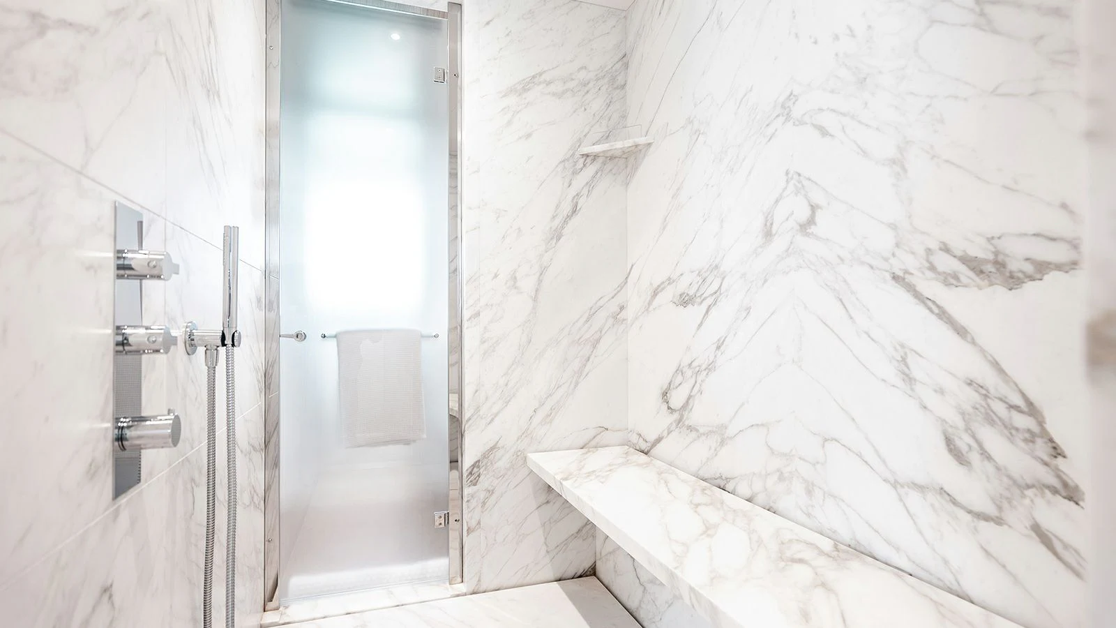 a white bathroom with a shower aboard KOJU Yacht for Sale