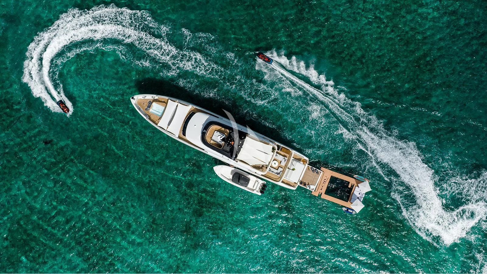 a small plane flying over the ocean aboard KOJU Yacht for Sale
