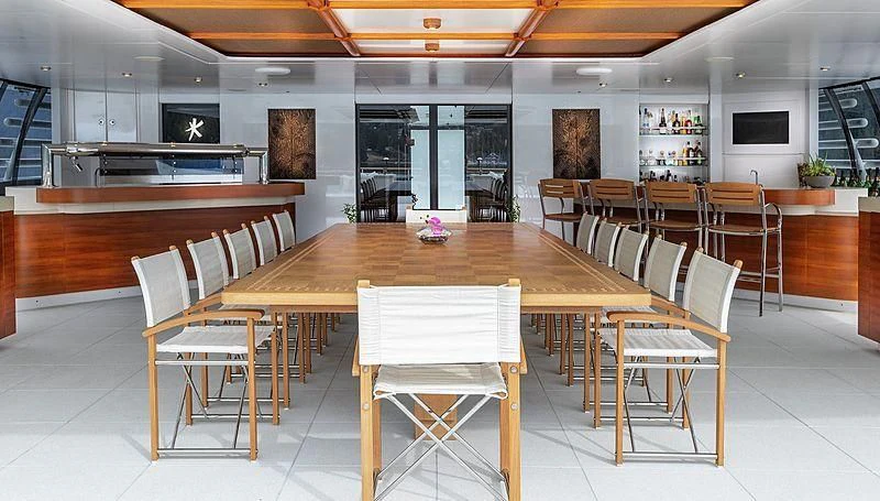 a large room with tables and chairs aboard KOJU Yacht for Sale