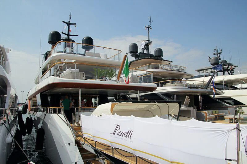 a boat docked with people standing on the deck aboard KOJU Yacht for Sale