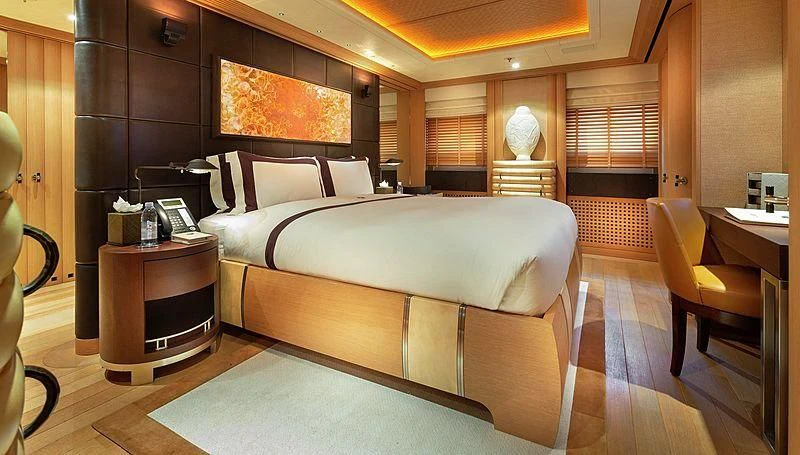 a room with a bed and a desk aboard KOJU Yacht for Sale