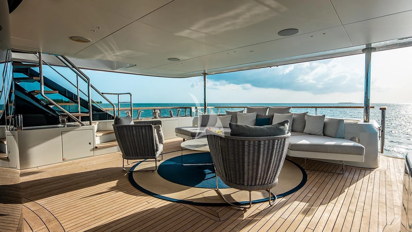 a living room with a large balcony aboard KOJU Yacht for Sale