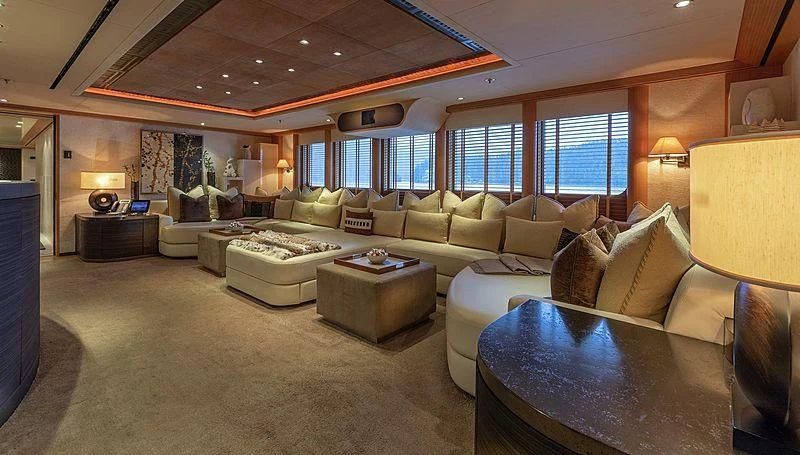 a living room with a large sofa aboard KOJU Yacht for Sale