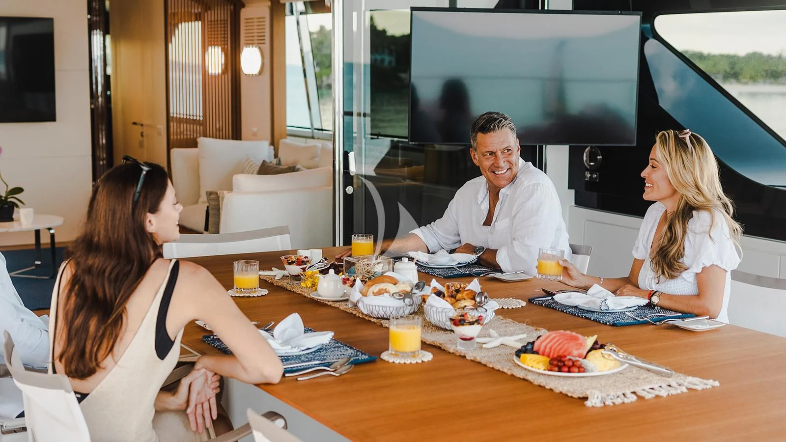 a family having breakfast in the living room aboard KOJU Yacht for Sale