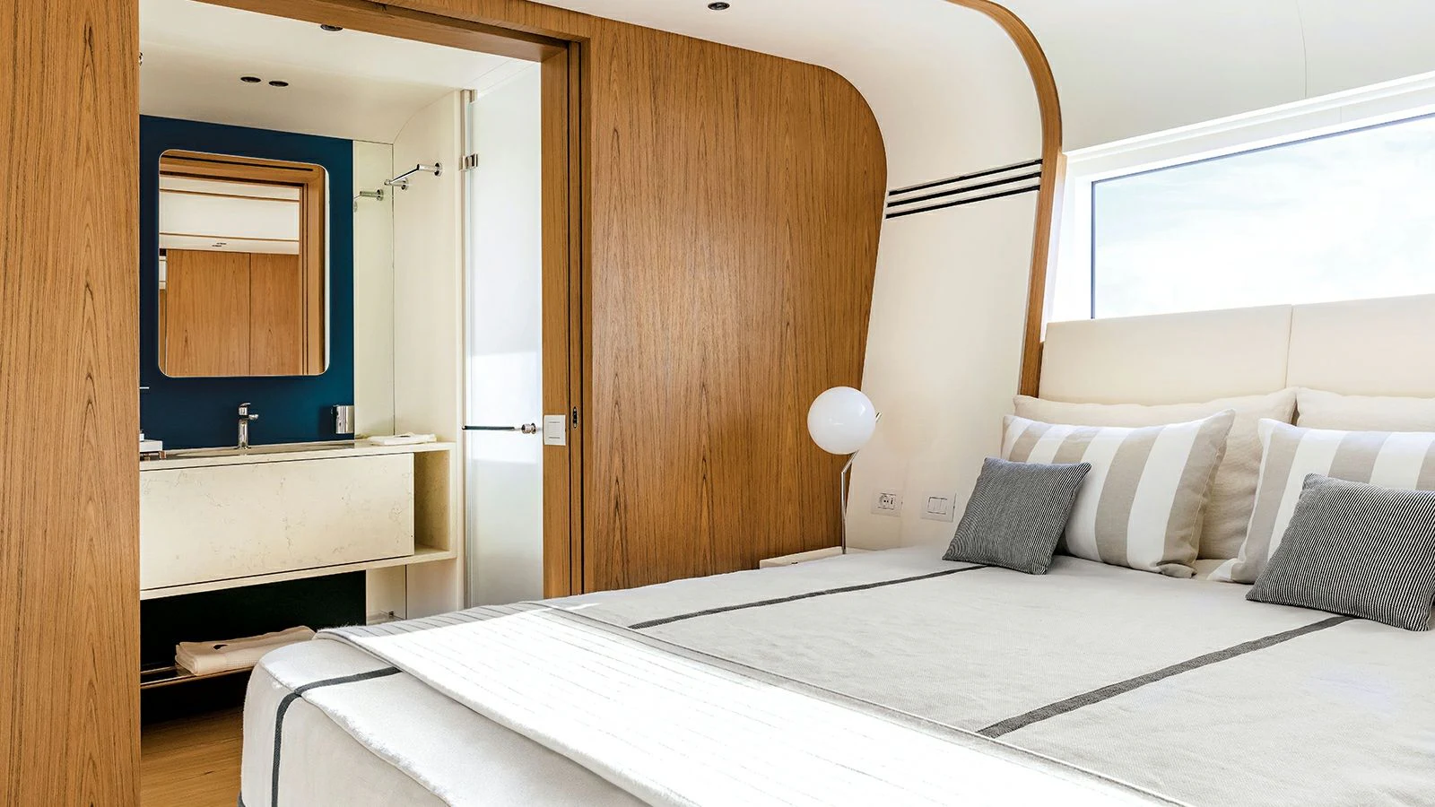 a bed with white sheets and pillows aboard KOJU Yacht for Sale