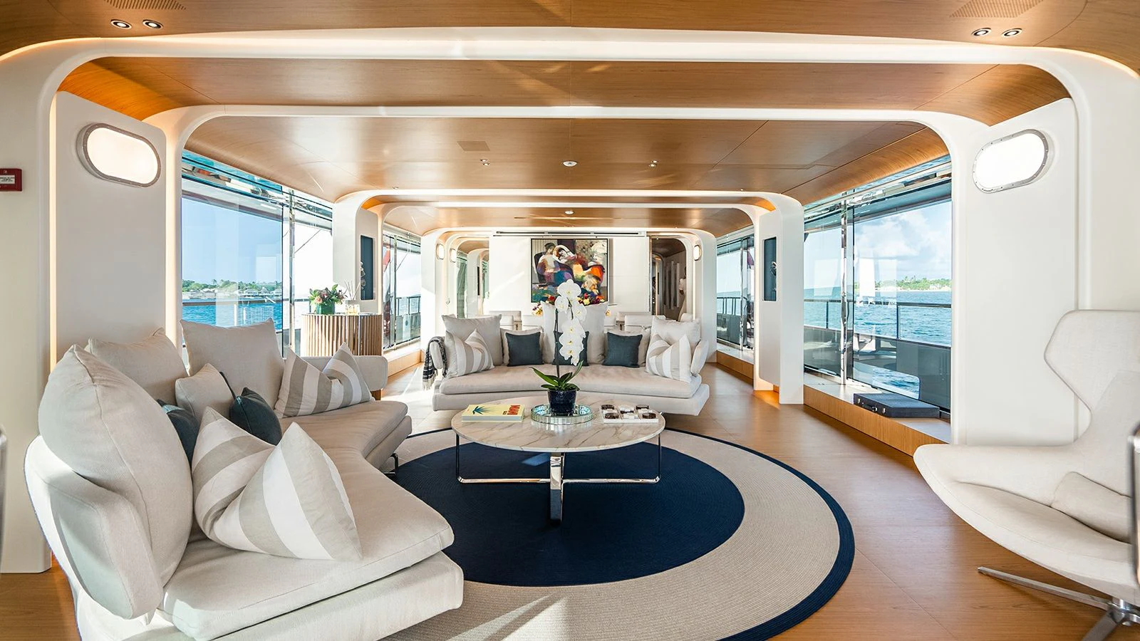 a living room with a large blue rug aboard KOJU Yacht for Sale