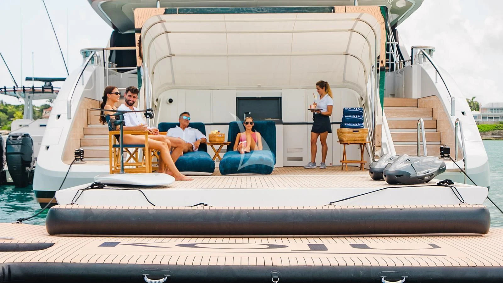 a group of people sitting on a boat aboard KOJU Yacht for Sale