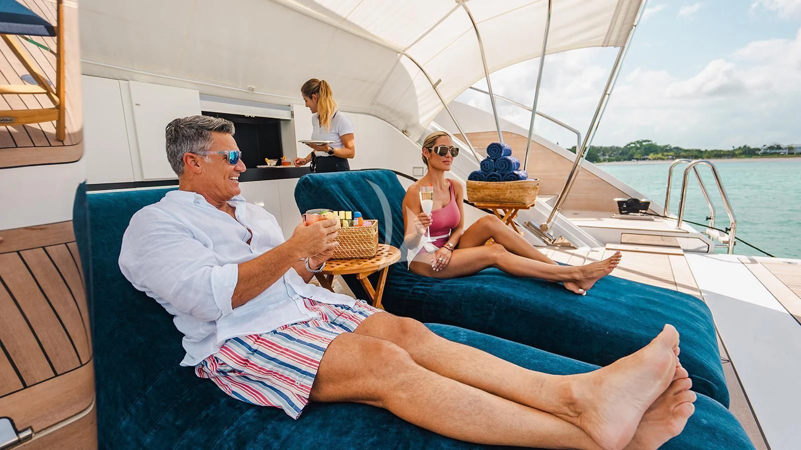 a group of people sitting on a boat aboard KOJU Yacht for Sale