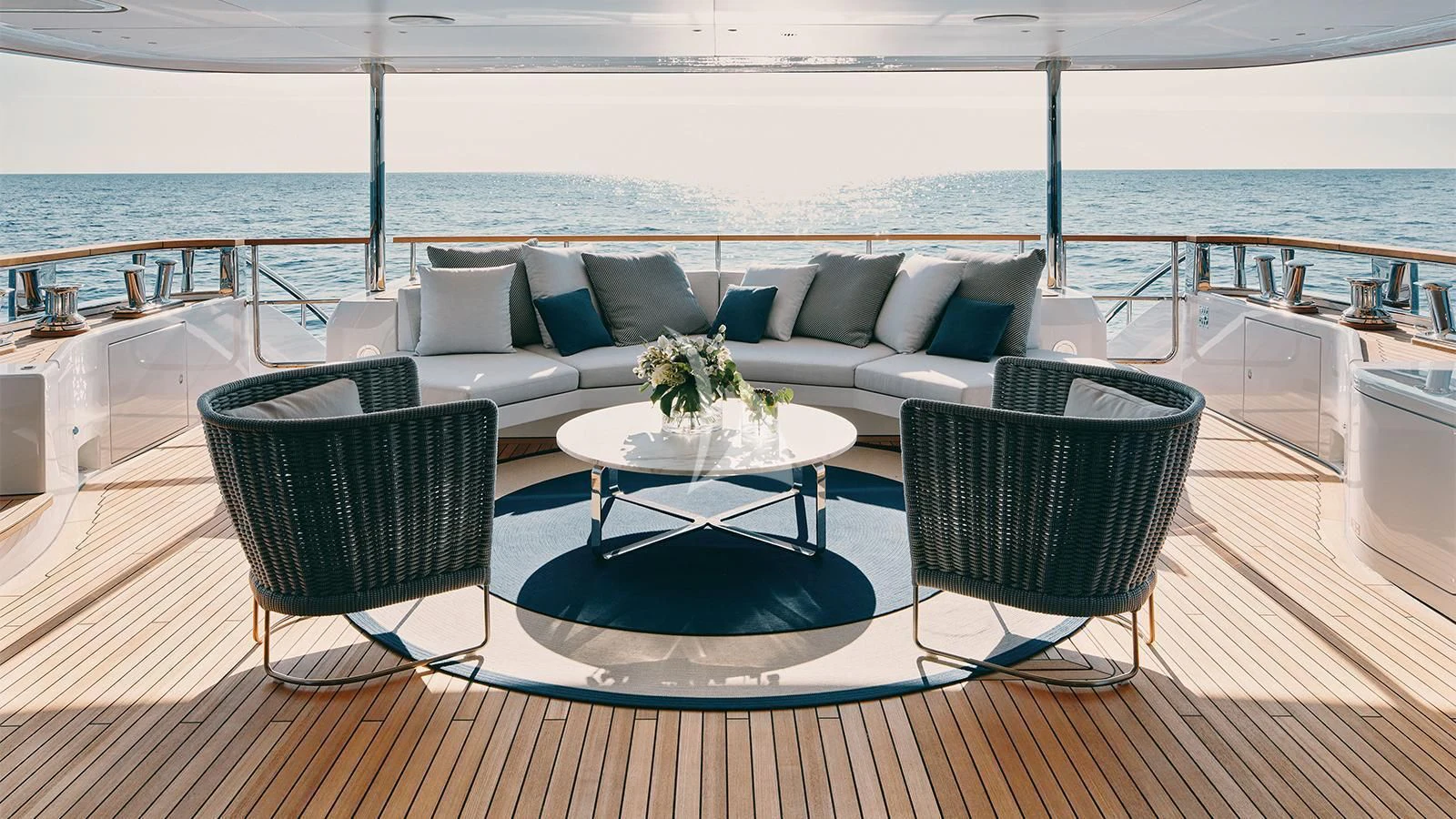 a couch and chairs on a deck aboard KOJU Yacht for Sale
