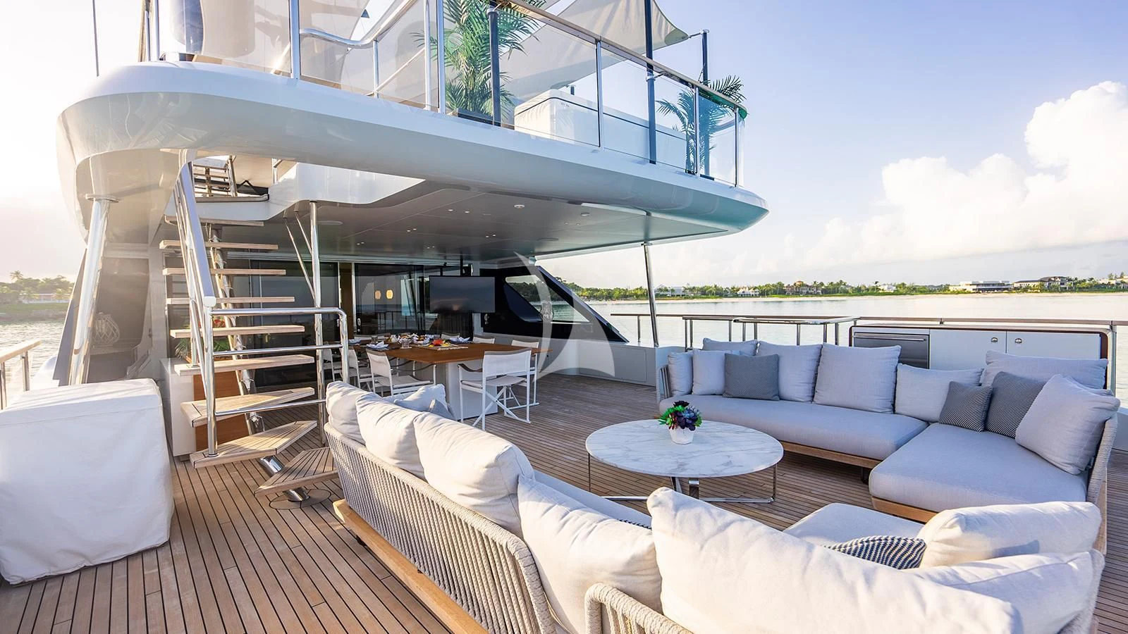 a living room with a large balcony aboard KOJU Yacht for Sale
