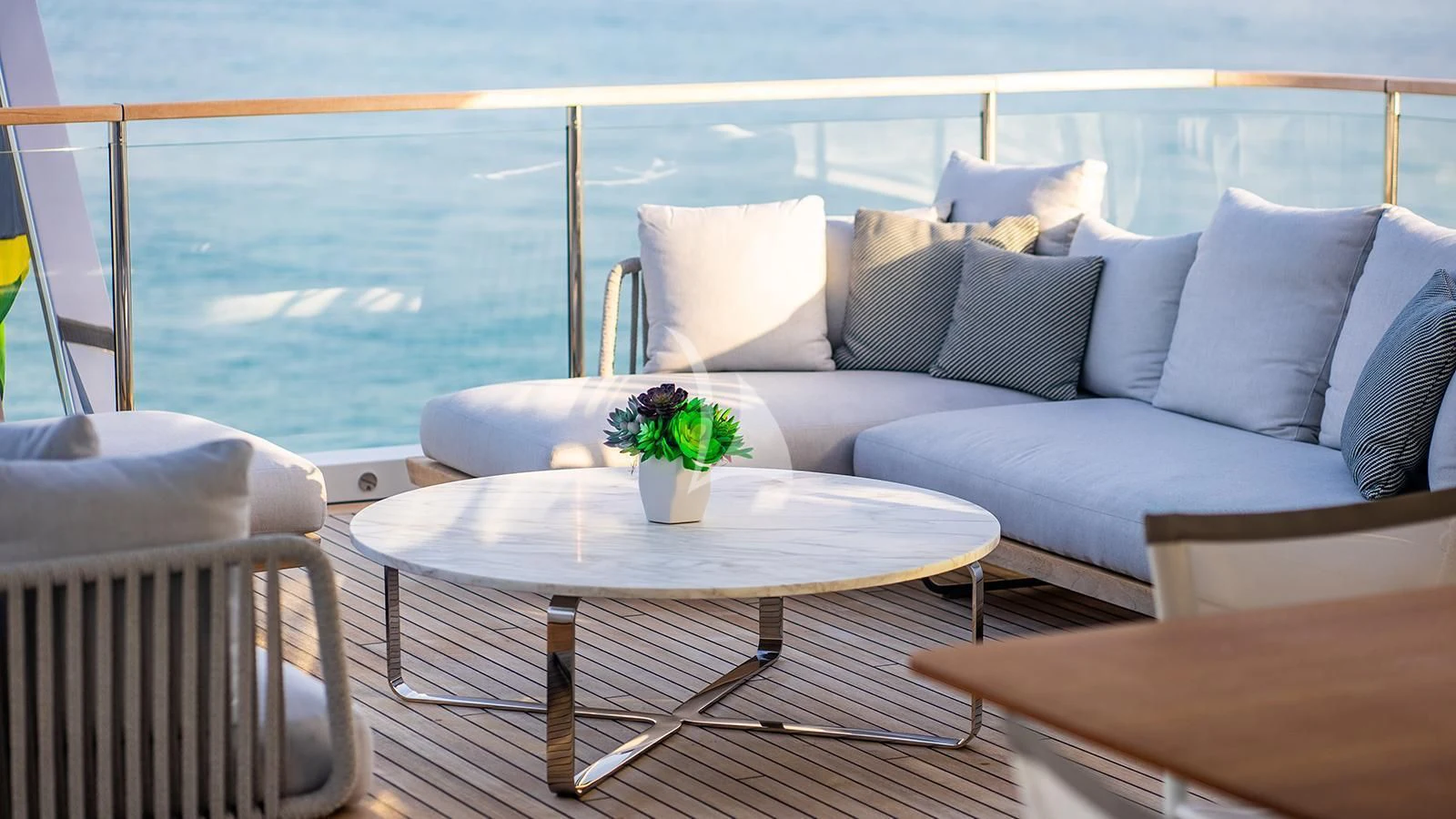 a table with pillows and a couch aboard KOJU Yacht for Sale