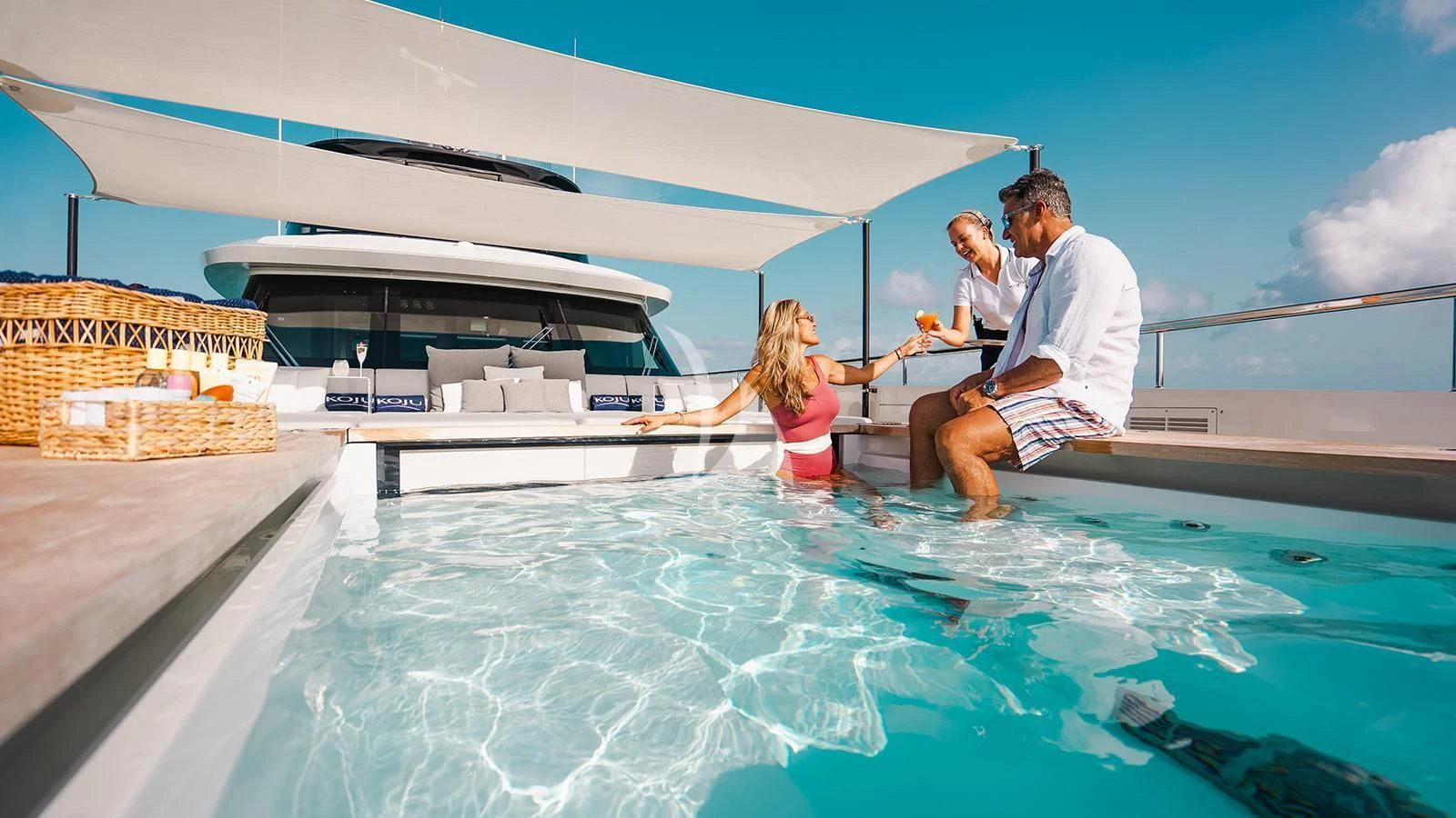 a man and woman in a pool aboard KOJU Yacht for Sale