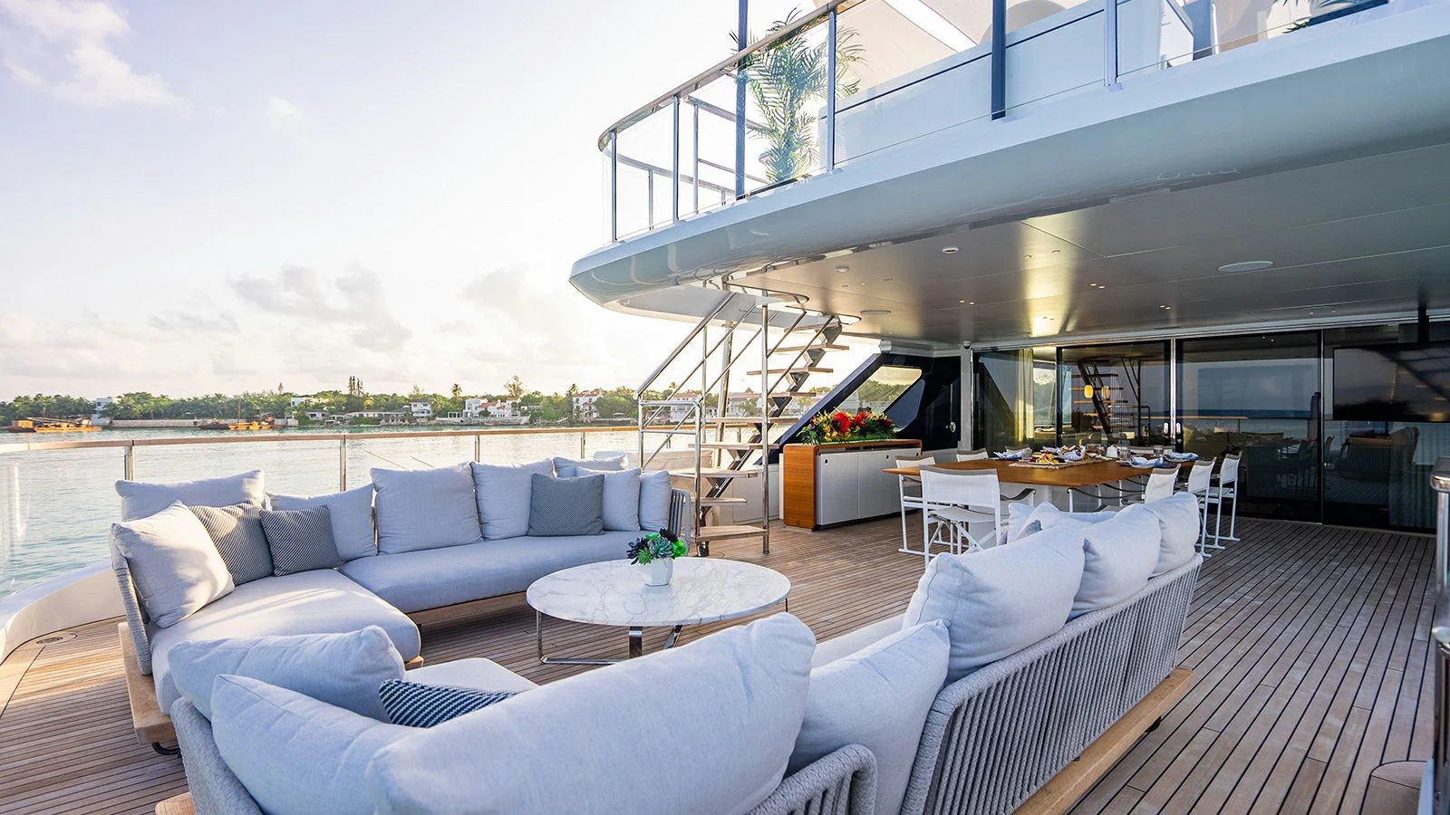 a living room with a large balcony aboard KOJU Yacht for Sale
