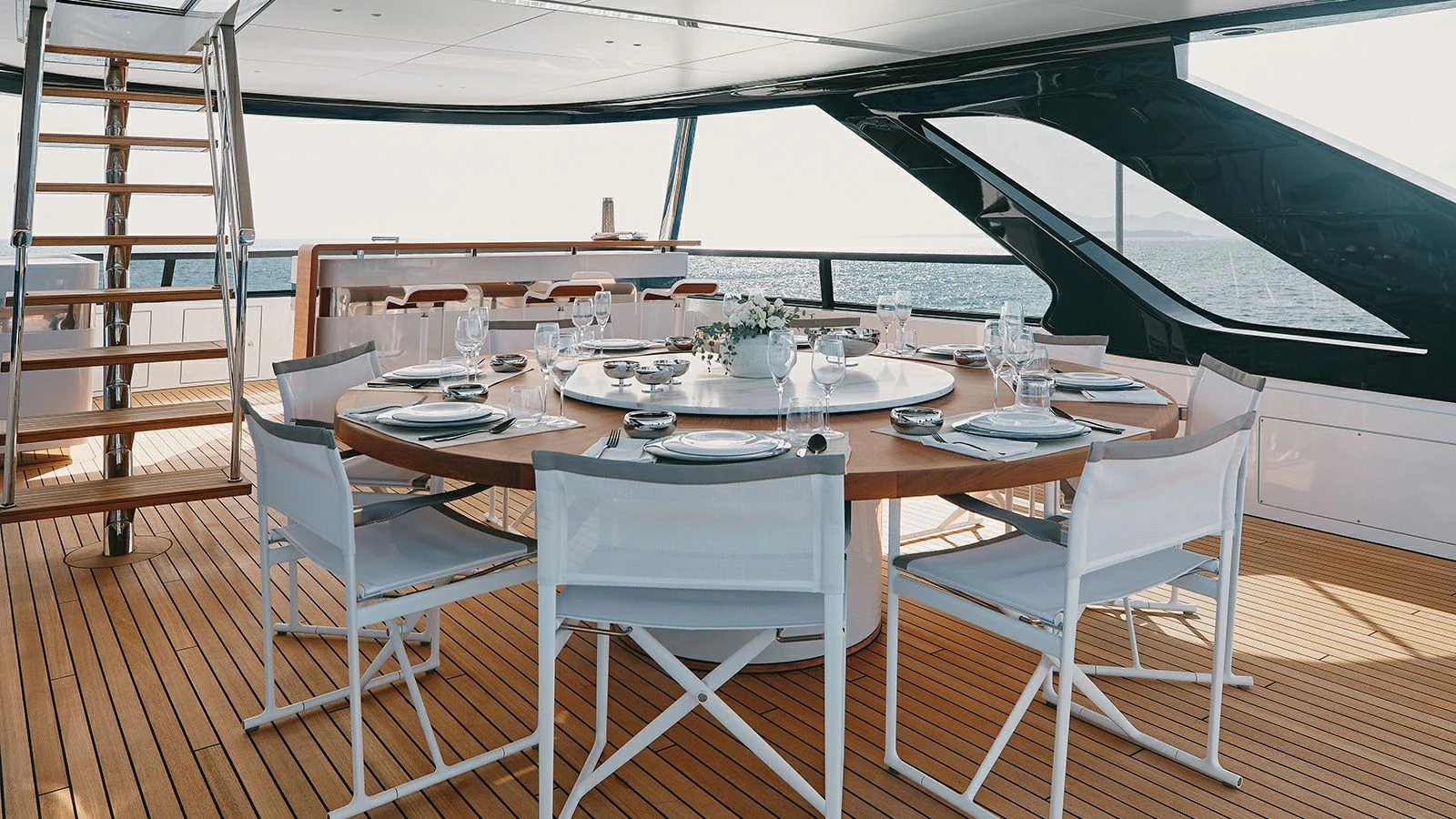 a table set with wine glasses aboard KOJU Yacht for Sale