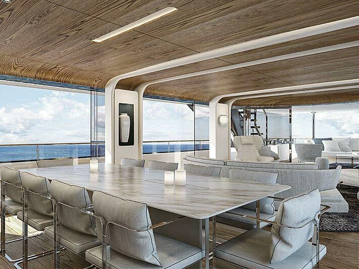 a large dining table in a room aboard KOJU Yacht for Sale