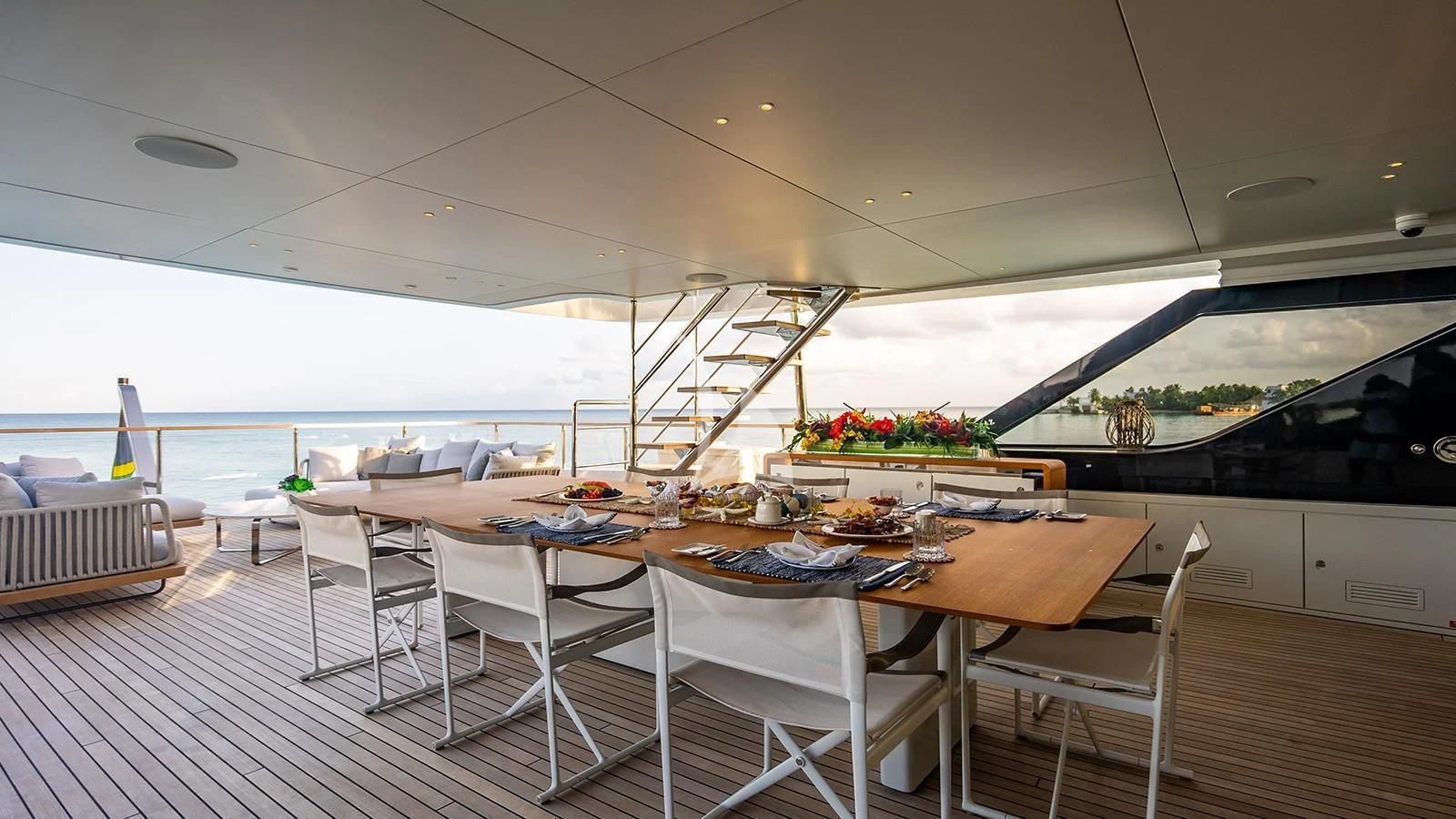 a dining table on a deck aboard KOJU Yacht for Sale