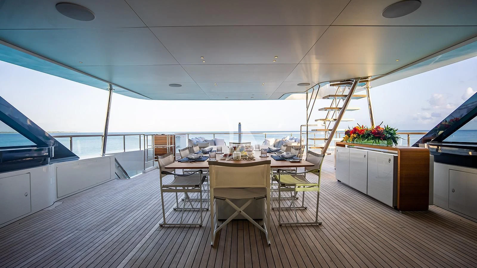 a room with a table and chairs aboard KOJU Yacht for Sale
