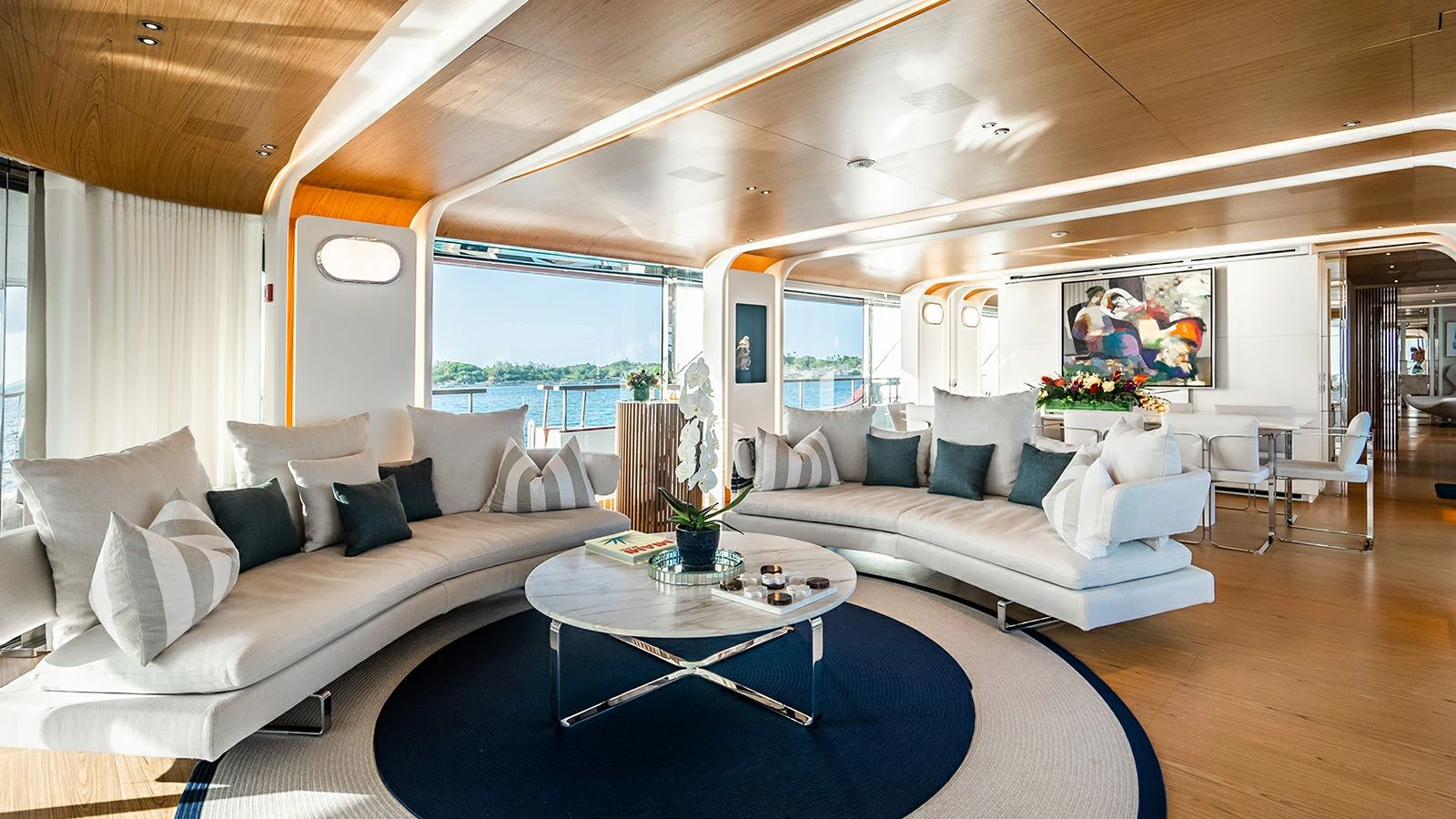 a living room with a blue rug aboard KOJU Yacht for Sale