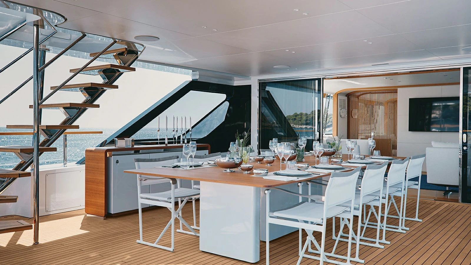 a large room with tables and chairs aboard KOJU Yacht for Sale