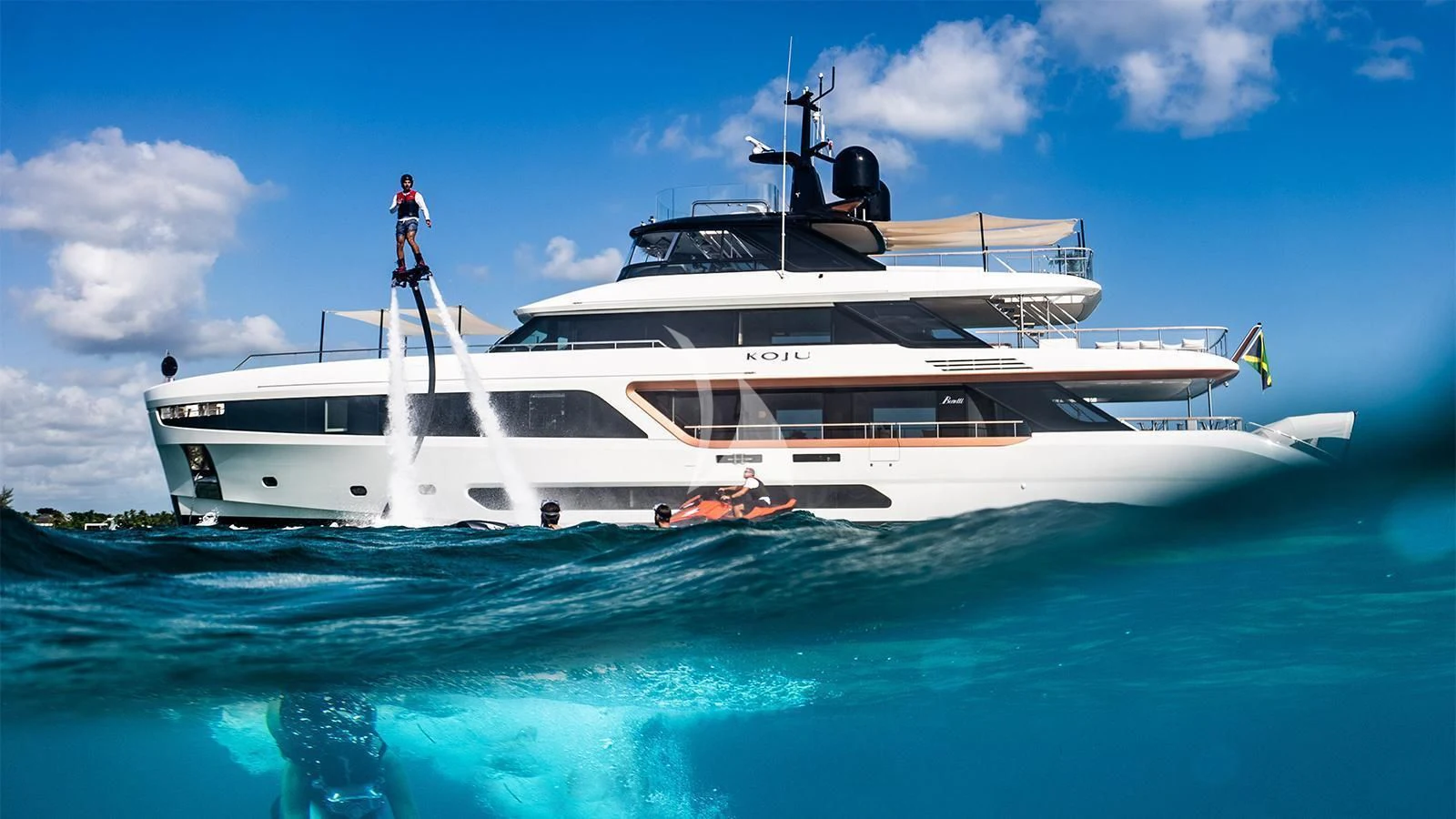 a white yacht in the water aboard KOJU Yacht for Sale
