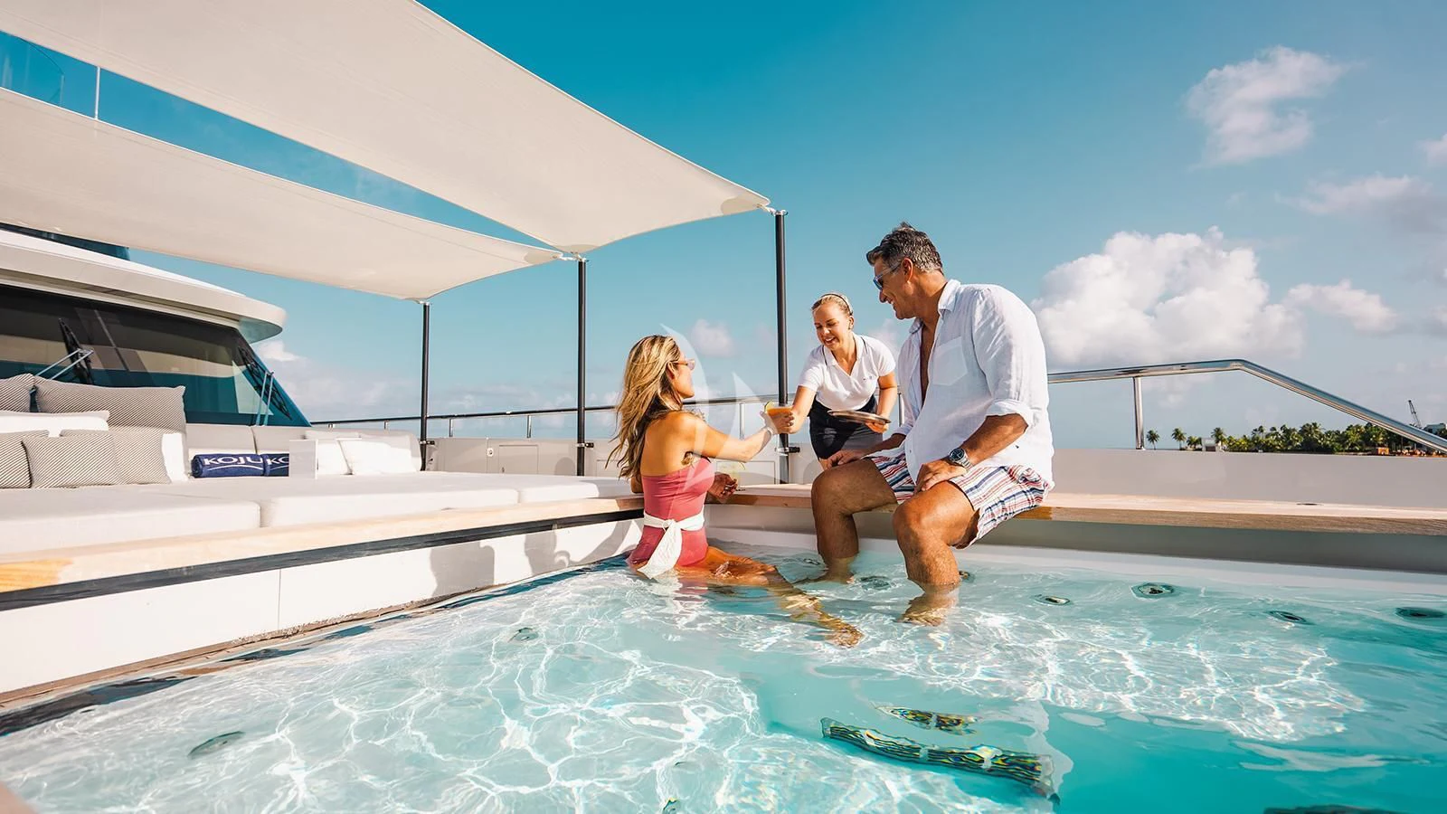 a group of people on a boat aboard KOJU Yacht for Sale