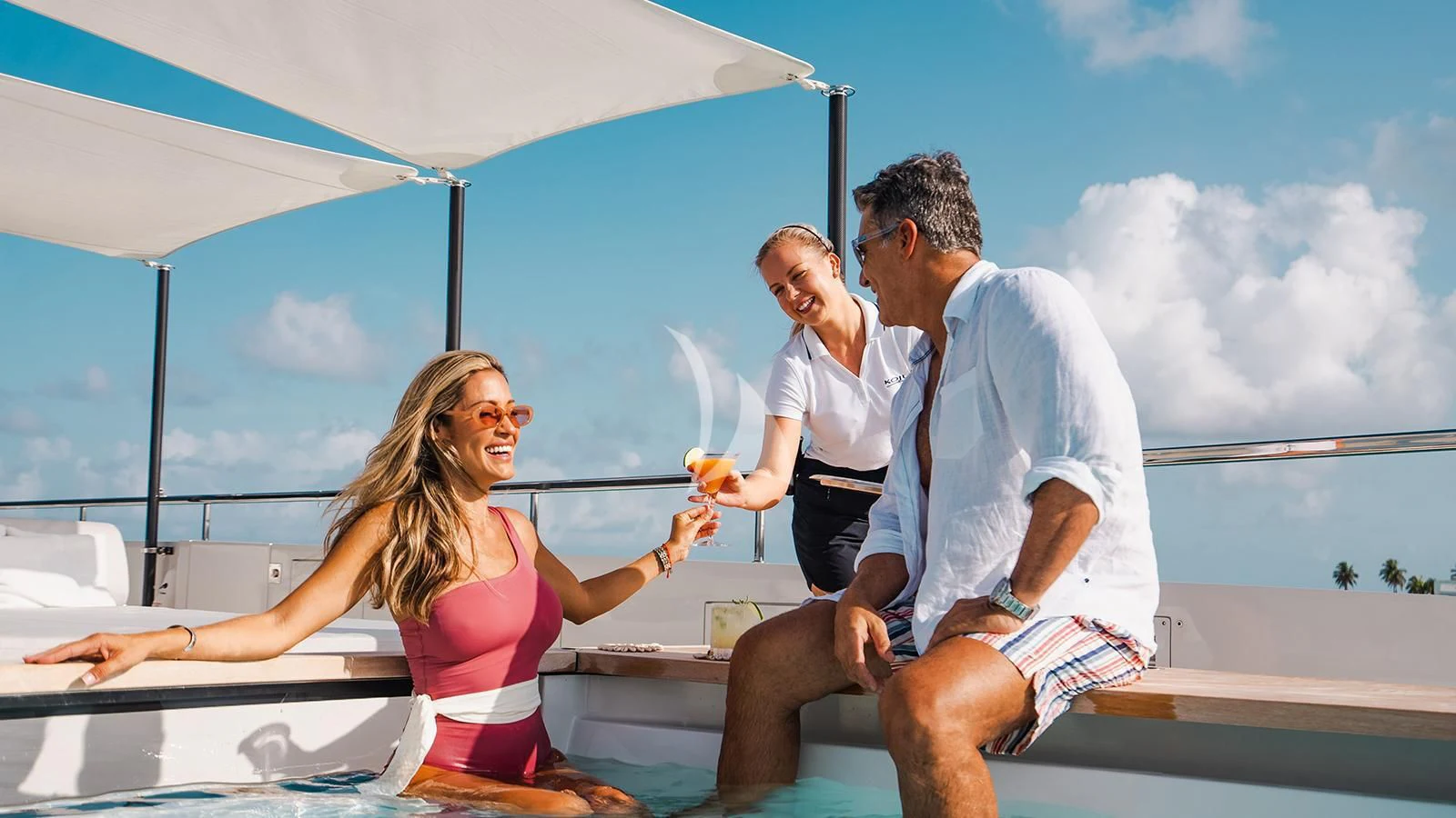 a group of people sitting on a boat aboard KOJU Yacht for Sale