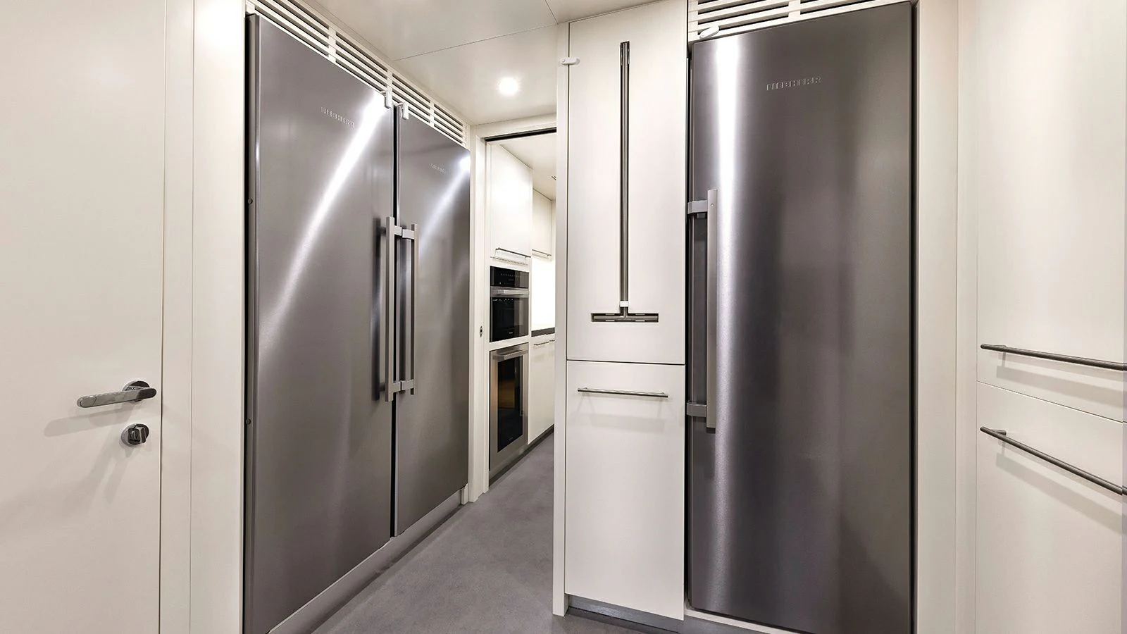 a row of refrigerators in a room aboard KOJU Yacht for Sale