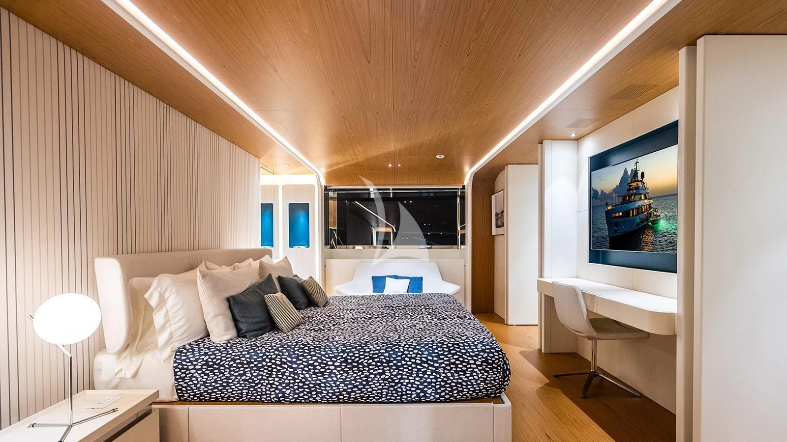 a bedroom with a bed and a tv on the wall aboard KOJU Yacht for Sale