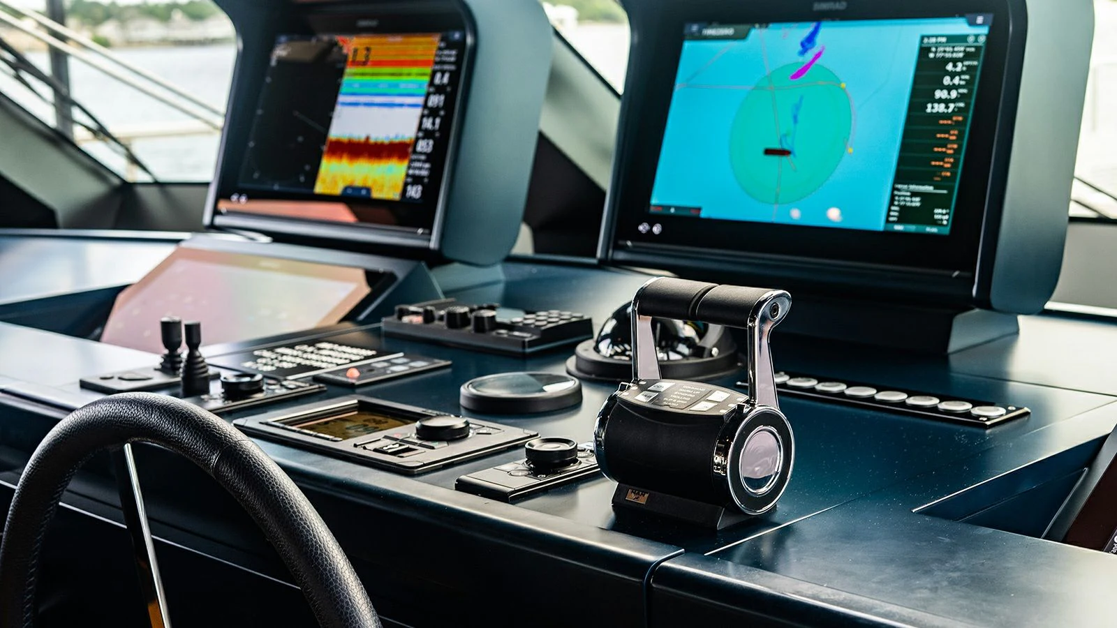 a desk with a computer and a screen aboard KOJU Yacht for Sale