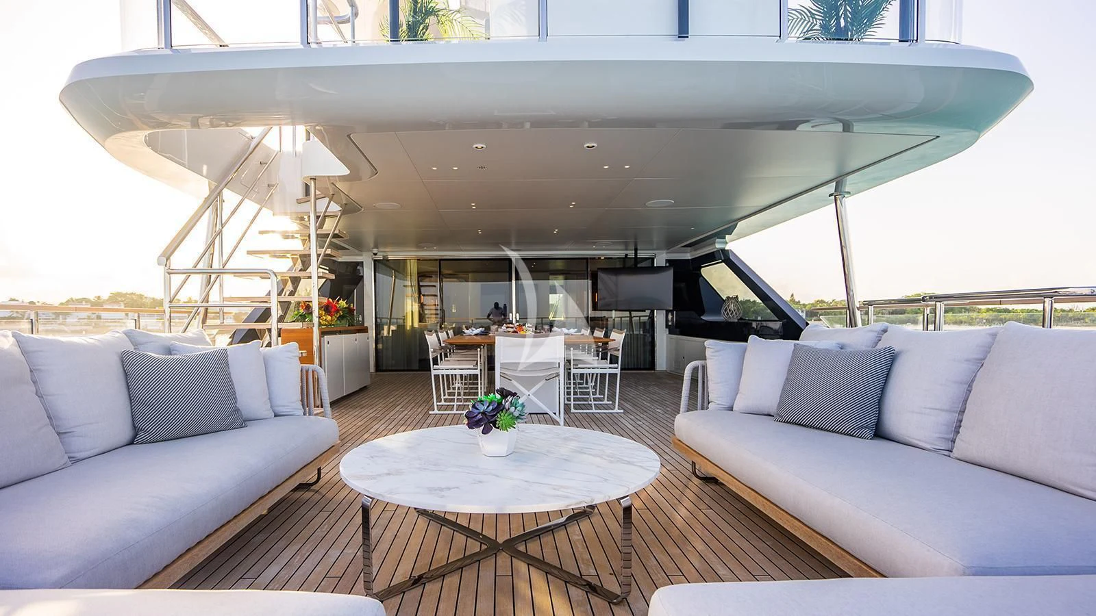 a living room with a large white table and a large white sofa aboard KOJU Yacht for Sale