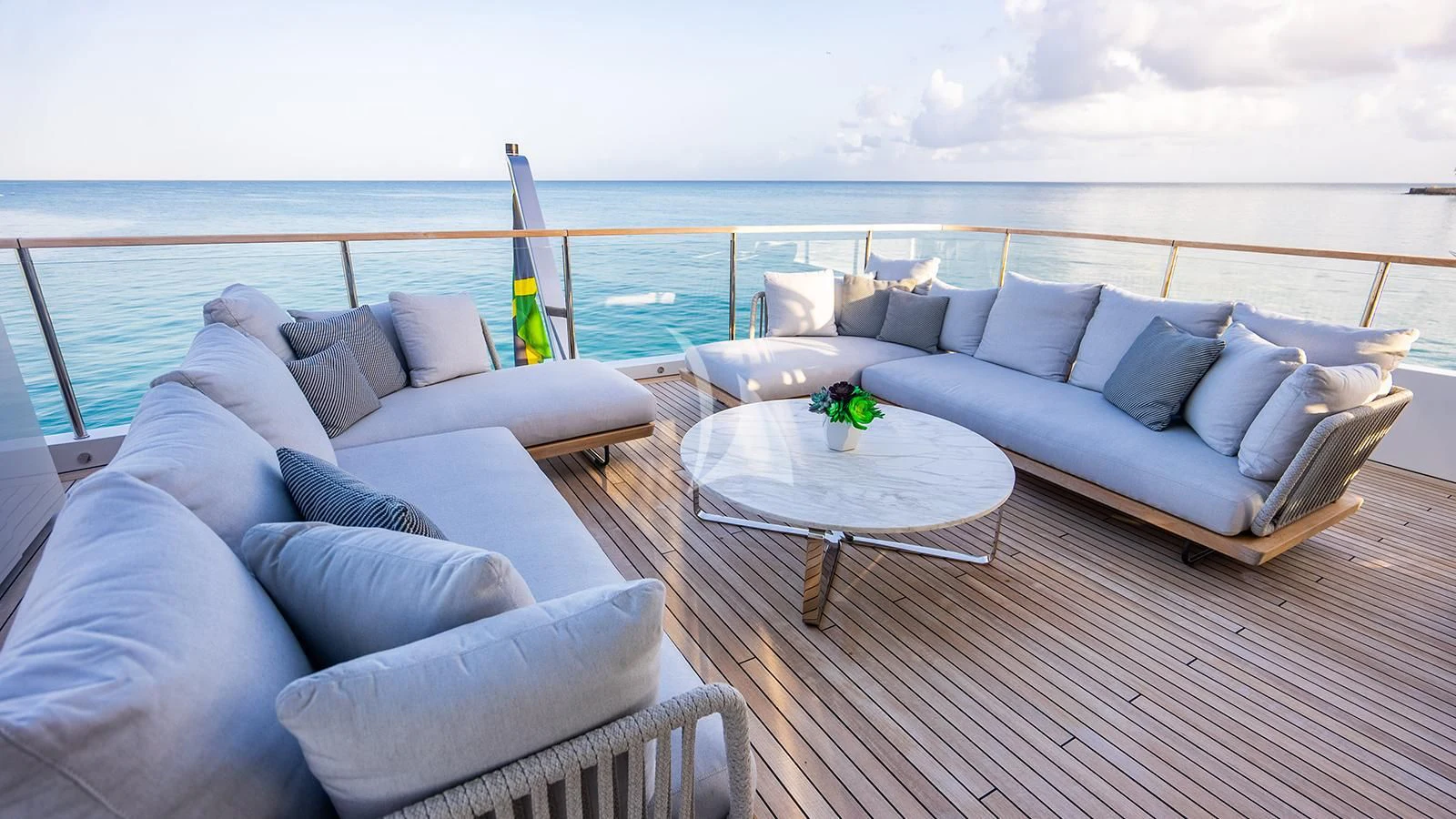 a living room with a large balcony overlooking the ocean aboard KOJU Yacht for Sale