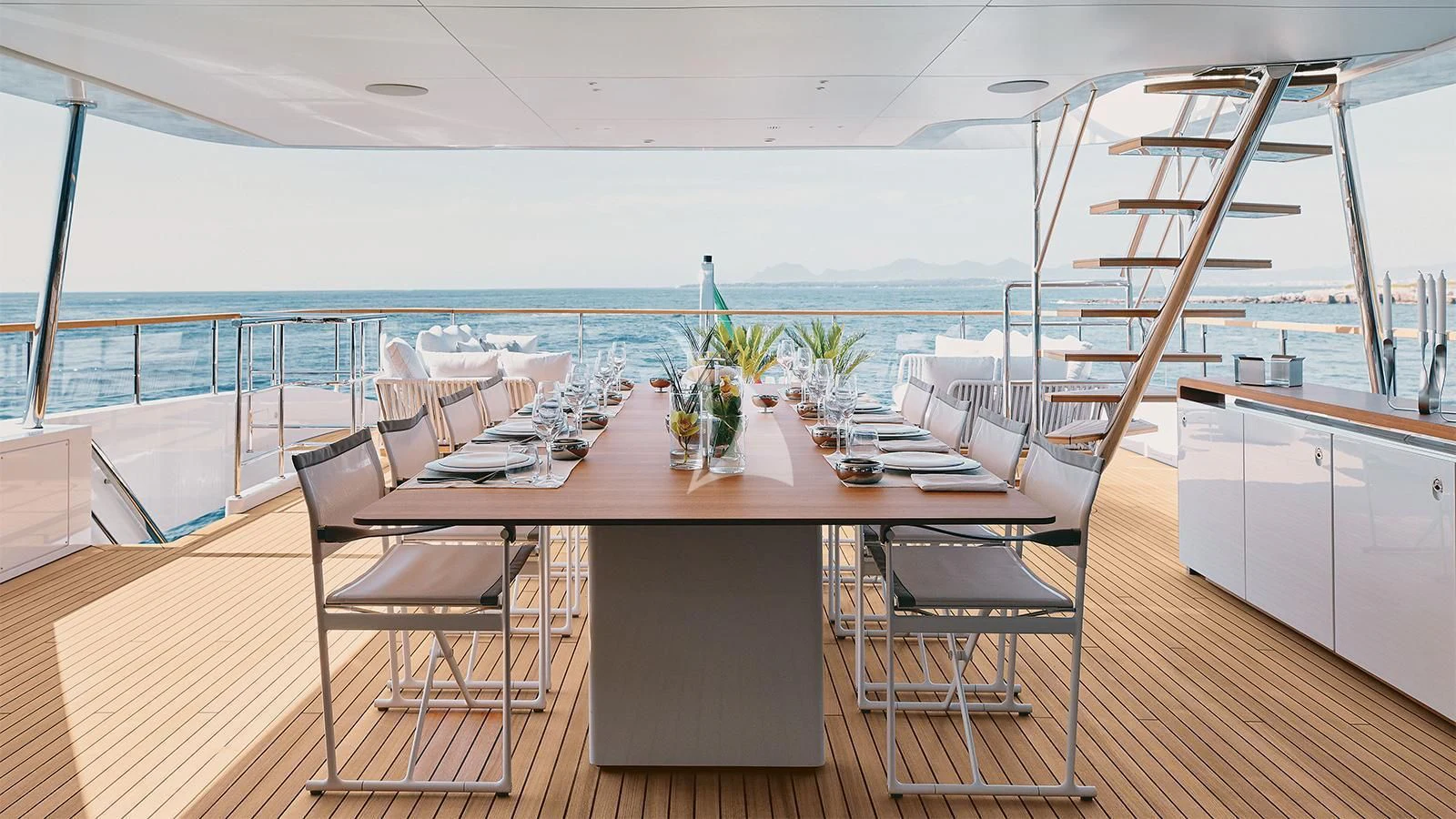 a large room with a table and chairs aboard KOJU Yacht for Sale