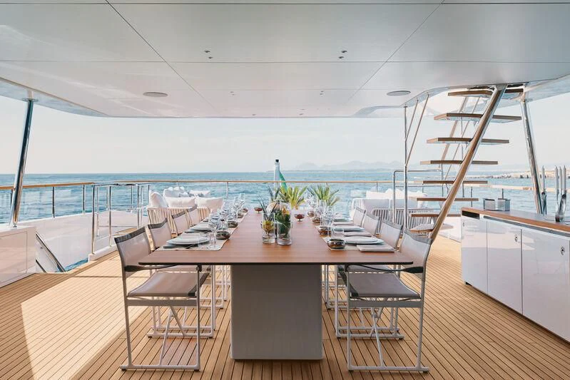 a large room with a table and chairs aboard KOJU Yacht for Sale