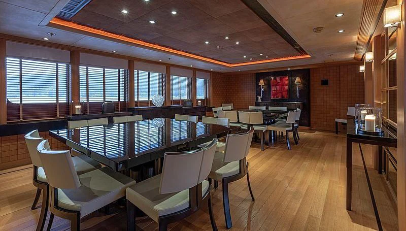a large room with a pool table and chairs aboard KOJU Yacht for Sale