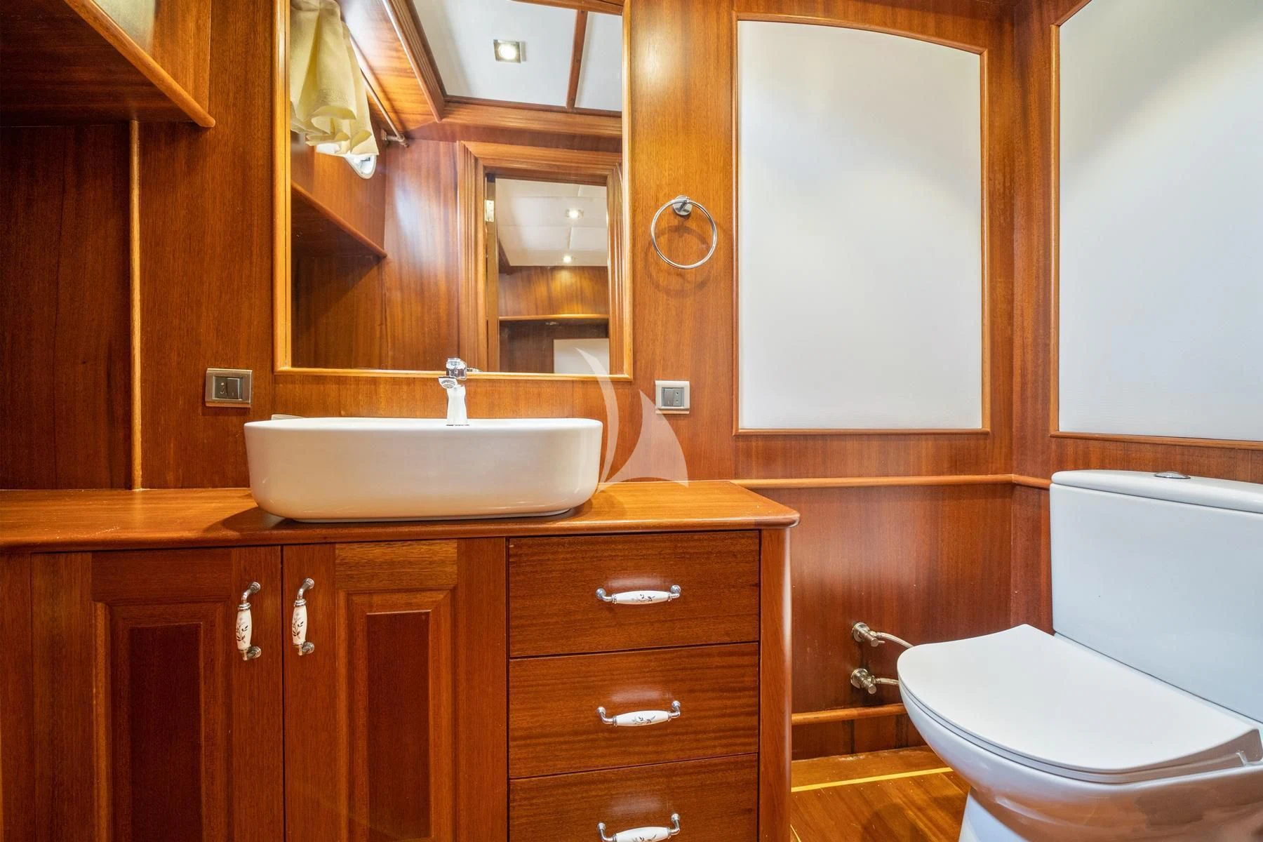 a bathroom with a sink and toilet aboard QUESTA VITA Yacht for Sale