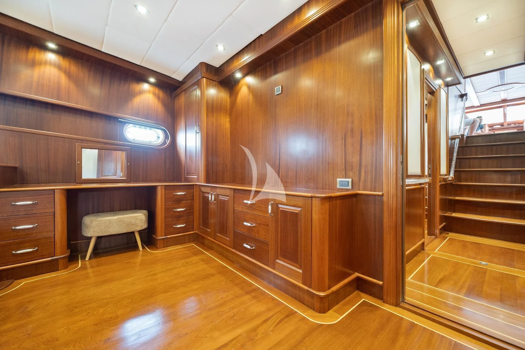 a room with wooden furniture aboard QUESTA VITA Yacht for Sale