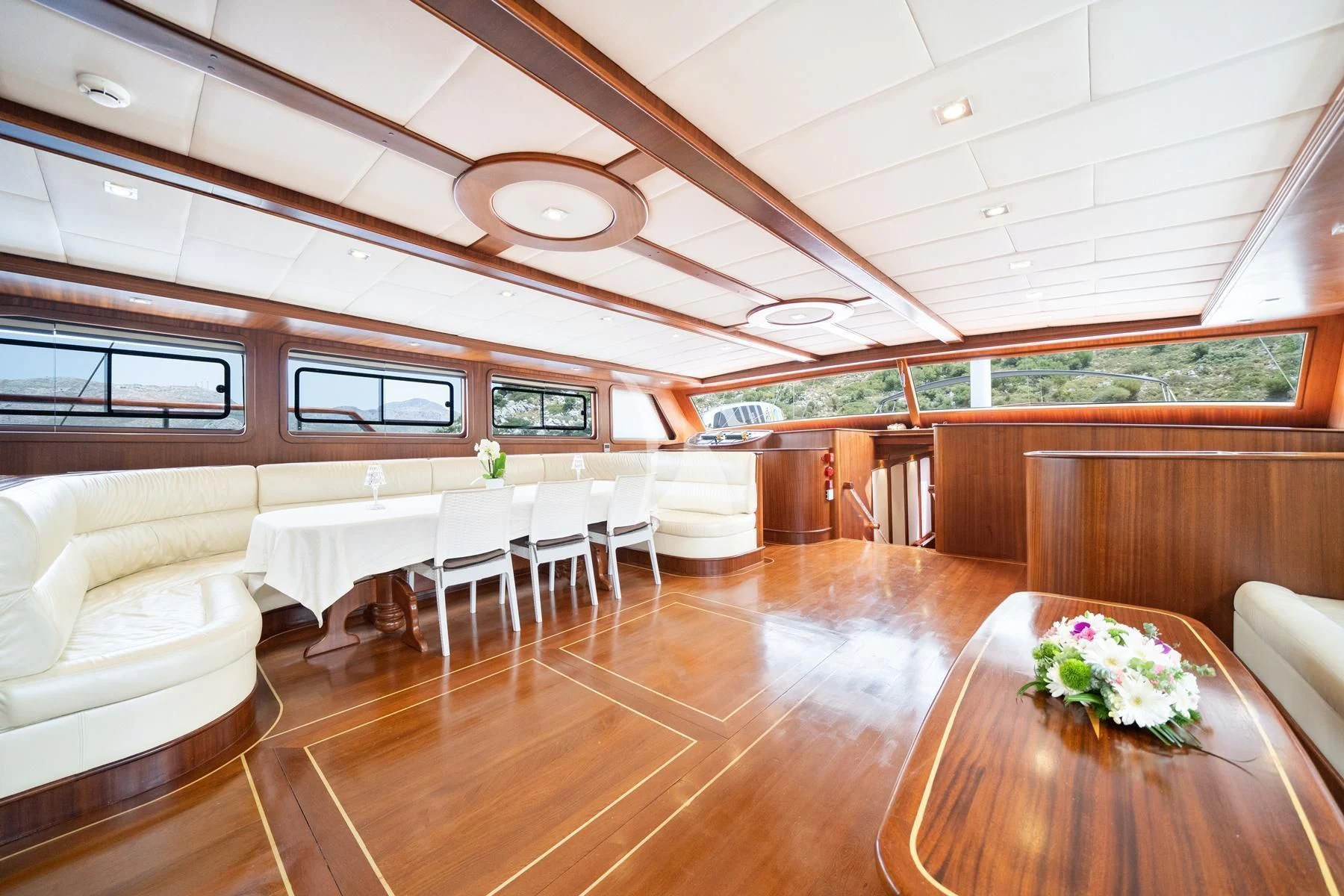 a room with tables and chairs aboard QUESTA VITA Yacht for Sale