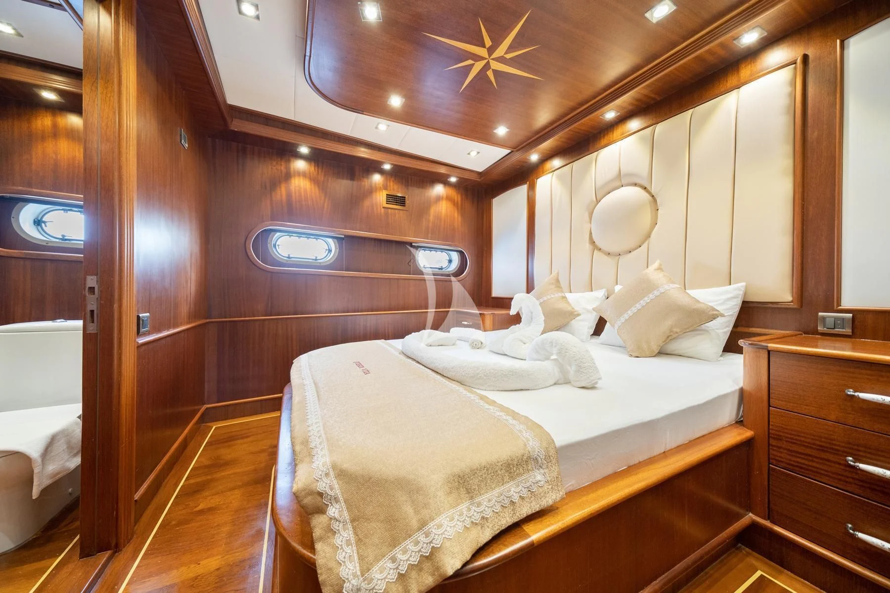 a room with a bed and a mirror aboard QUESTA VITA Yacht for Sale