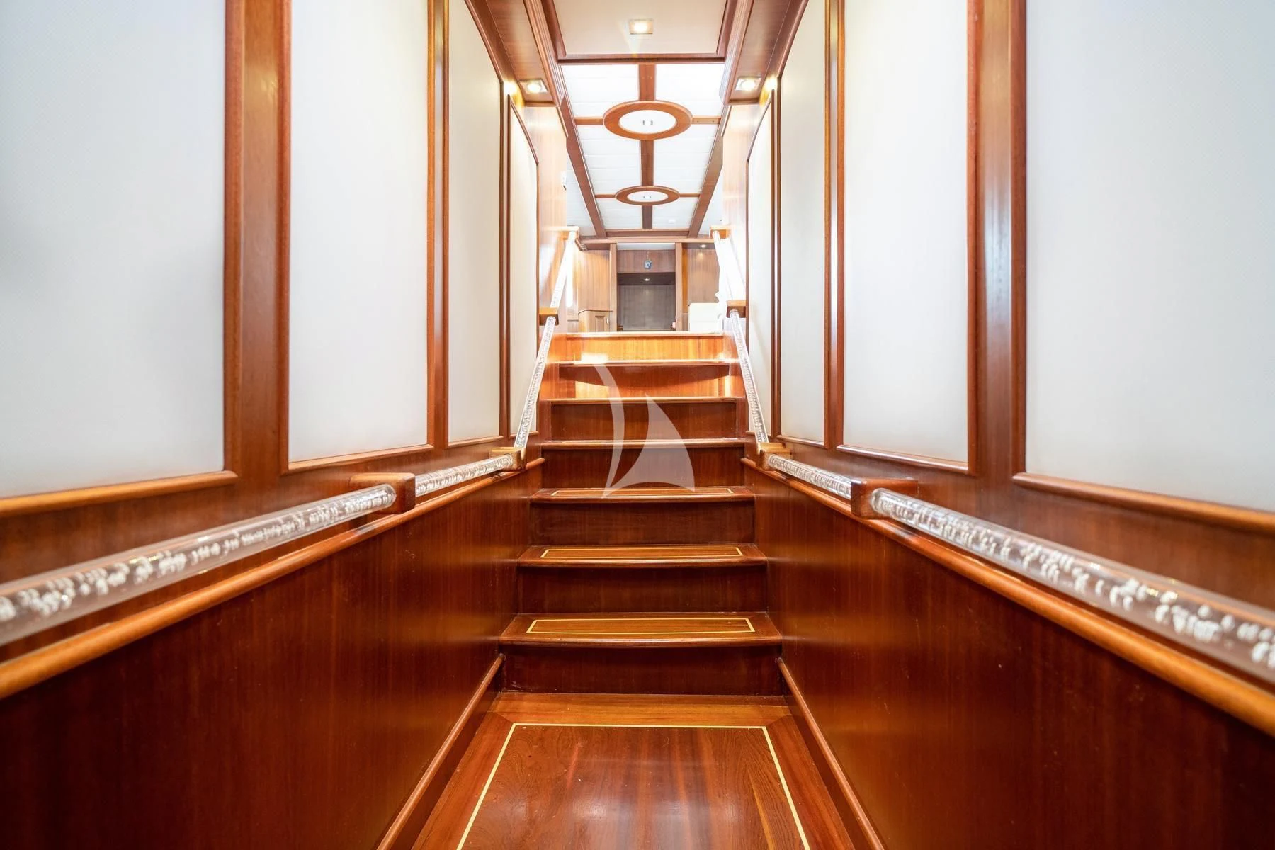 a wooden staircase with a glass ceiling aboard QUESTA VITA Yacht for Sale