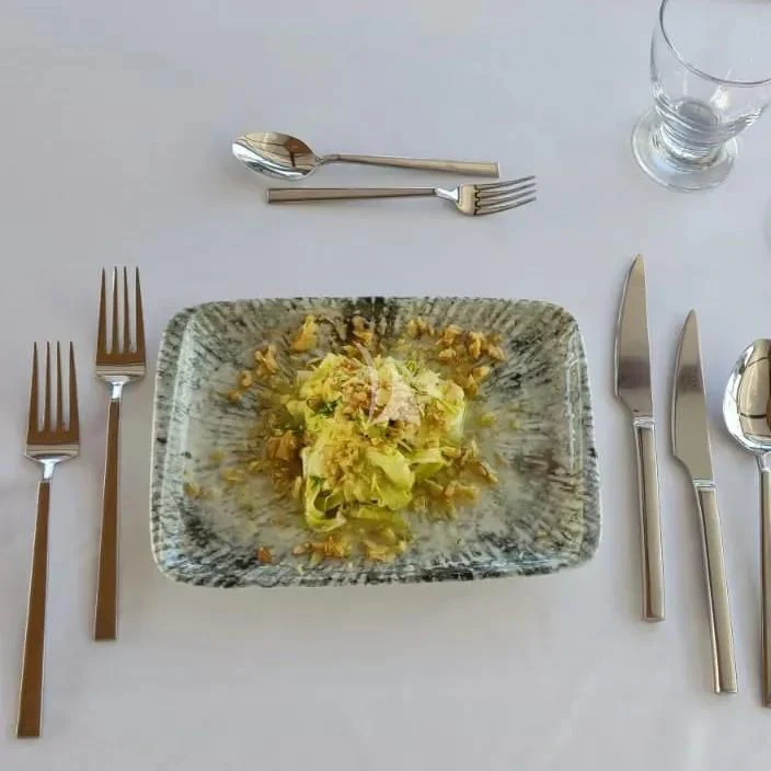 a plate of food and silverware aboard QUESTA VITA Yacht for Sale