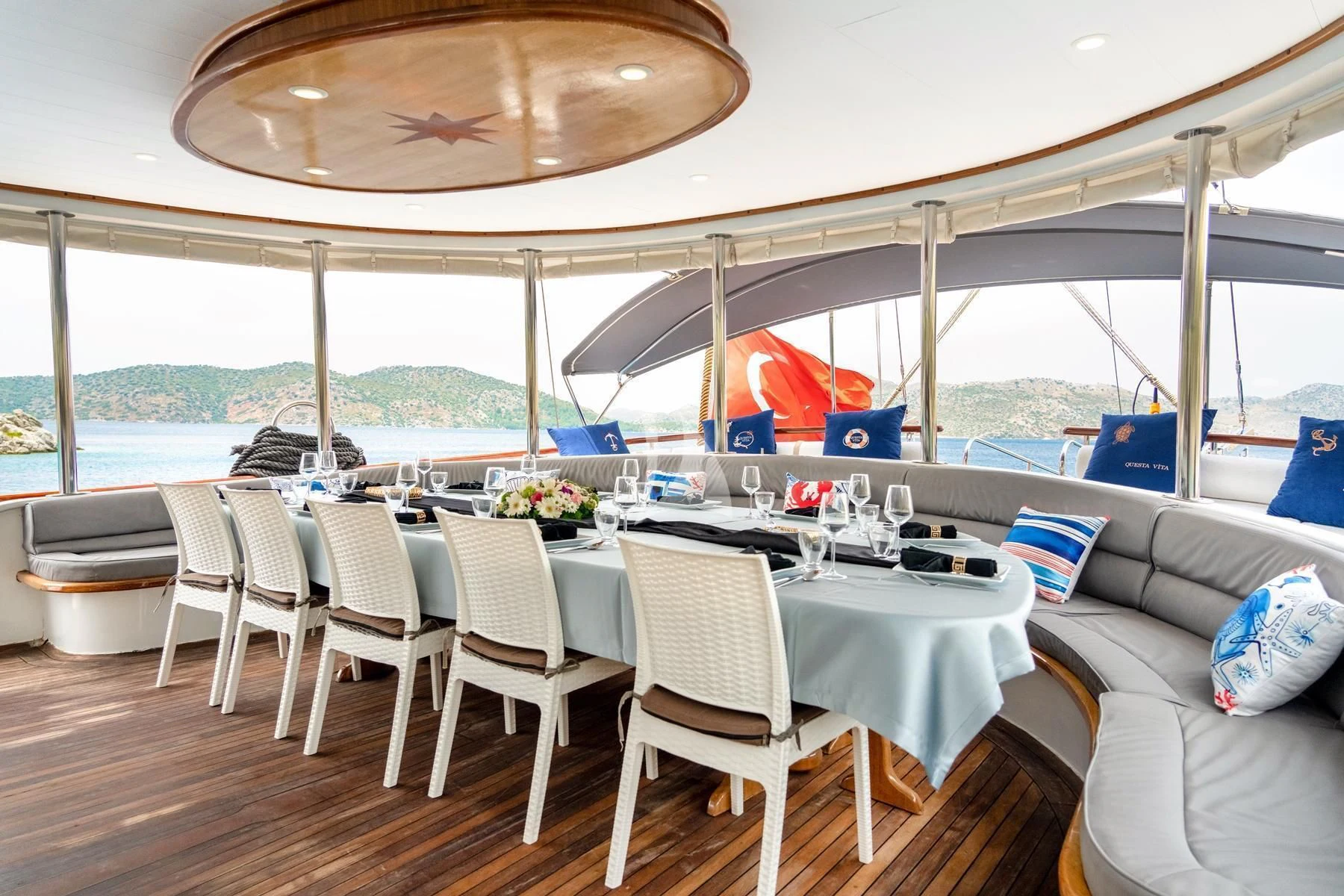 a table set for a meal aboard QUESTA VITA Yacht for Sale