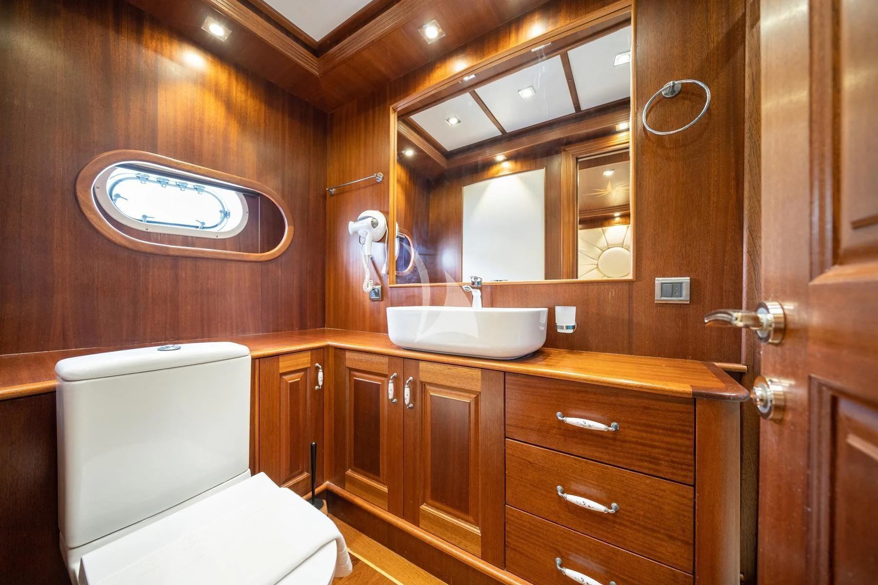 a bathroom with a toilet and a sink aboard QUESTA VITA Yacht for Sale