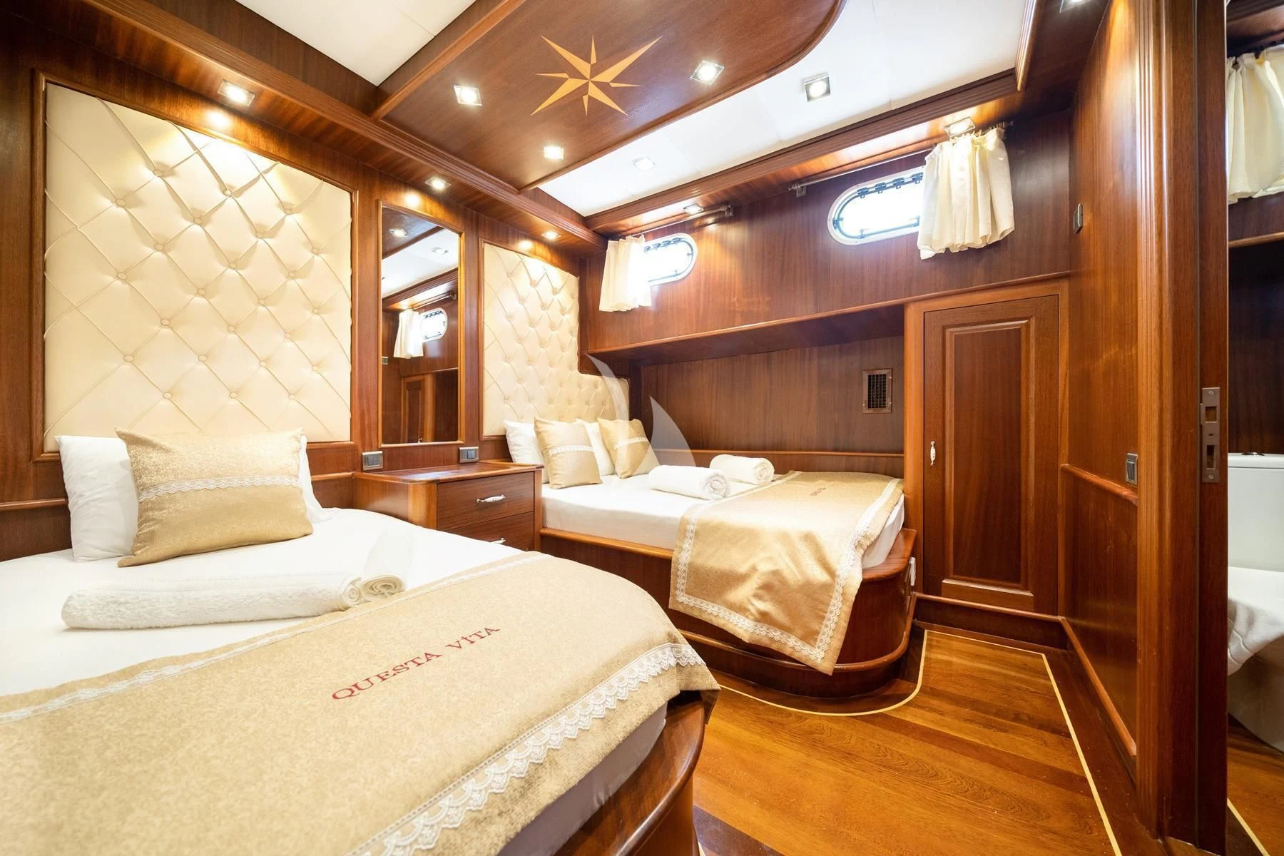 a room with two beds aboard QUESTA VITA Yacht for Sale