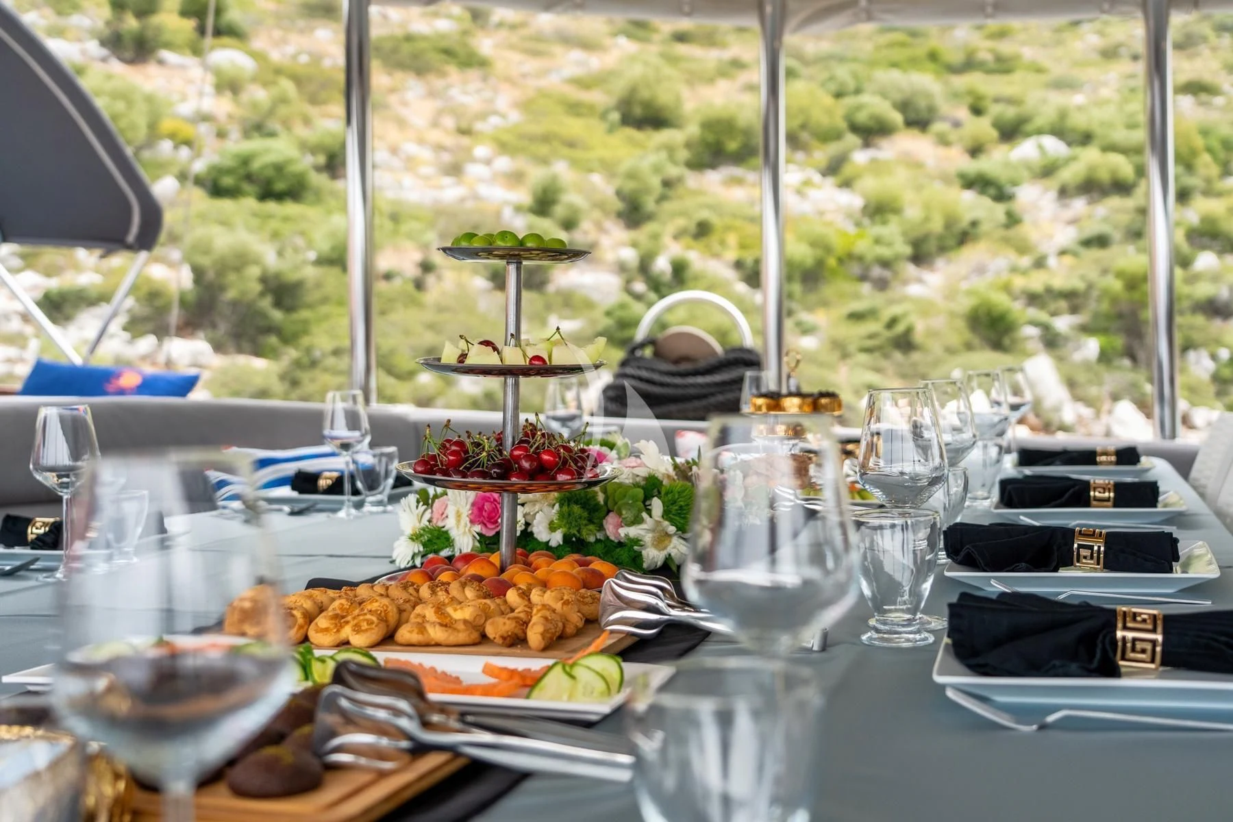 a table with food and glasses aboard QUESTA VITA Yacht for Sale