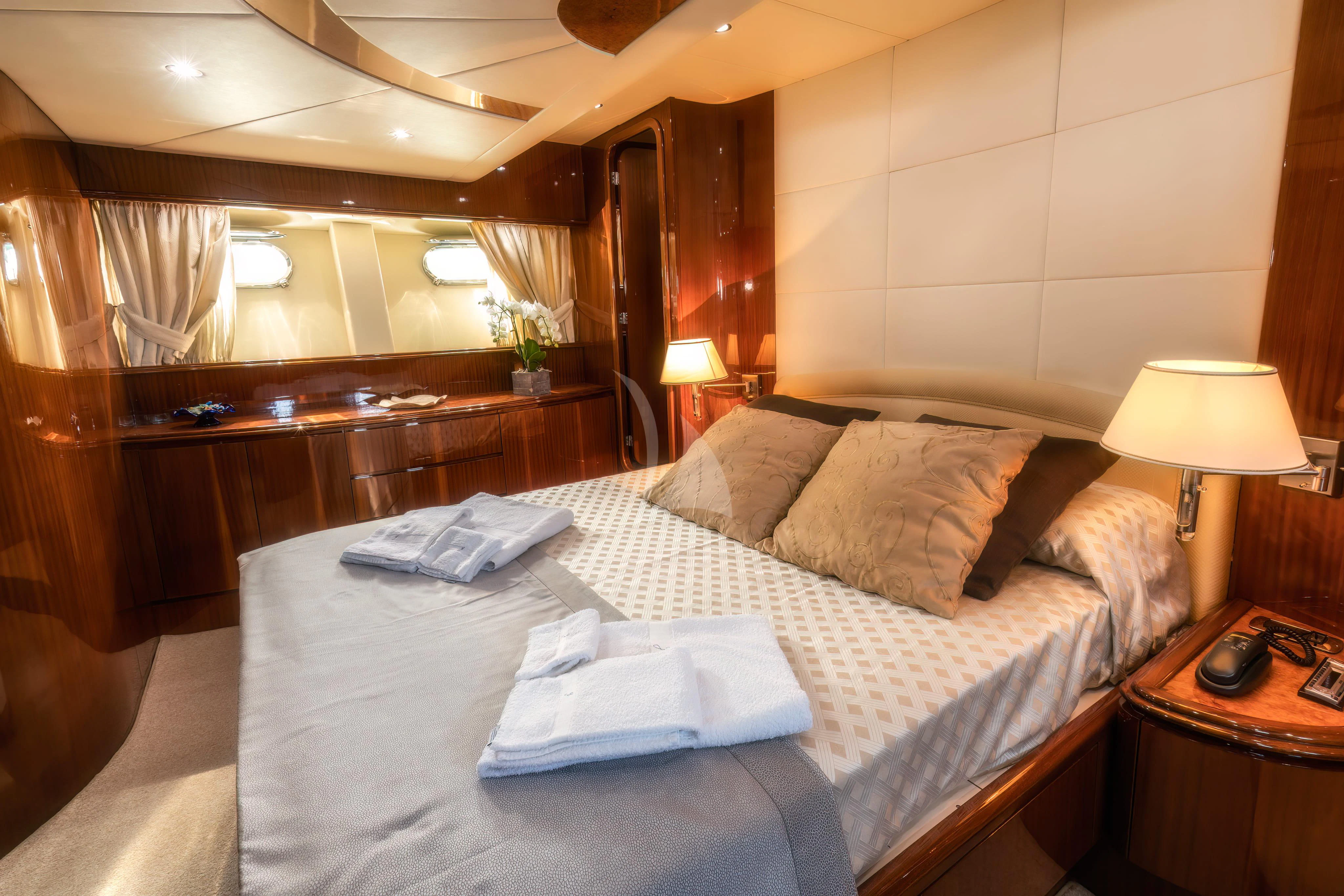 a bed with a white comforter aboard JAUNI Yacht for Sale
