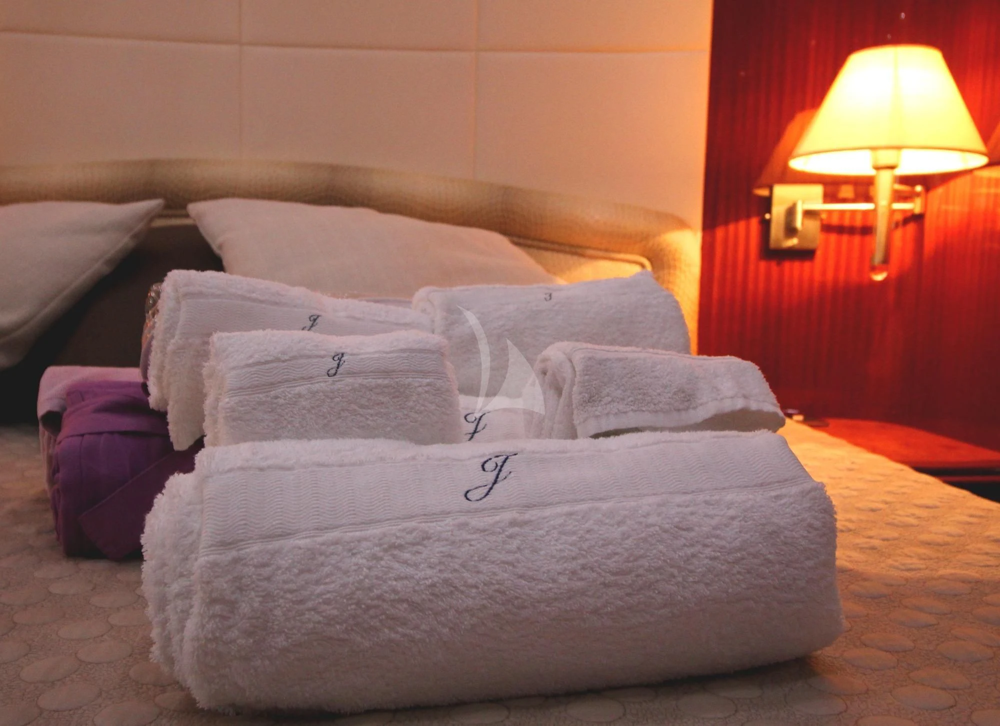 a bed with pillows aboard JAUNI Yacht for Sale